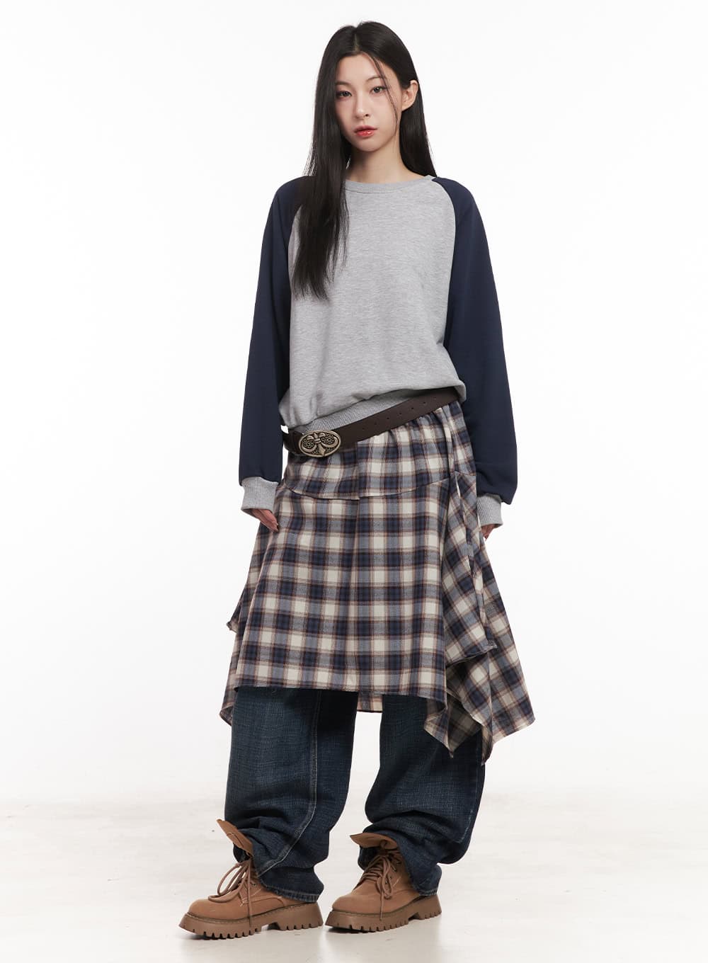 Annie Washed Wide-Leg Jeans CM518 in dark blue, front full-body editorial shot on model, relaxed wide-fit denim under plaid asymmetric skirt with statement belt and chunky boots.