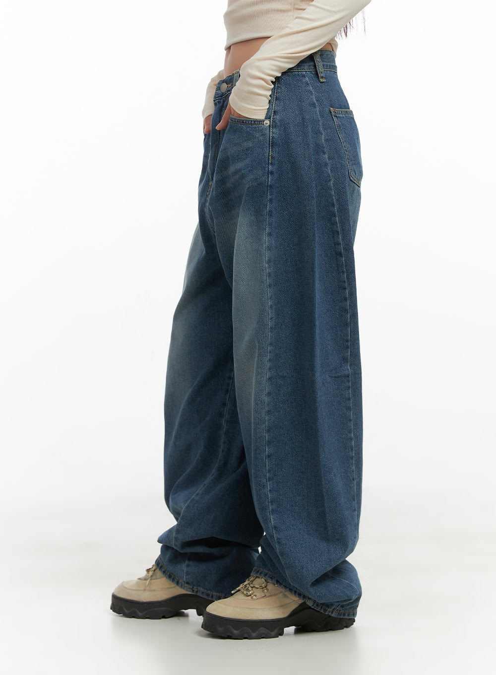 Lacey Washed Denim Baggy Jeans CO404 in blue, side close-up on model, highlighting balloon-style wide leg, washed fading detail, and stitched seam line, with chunky boots.