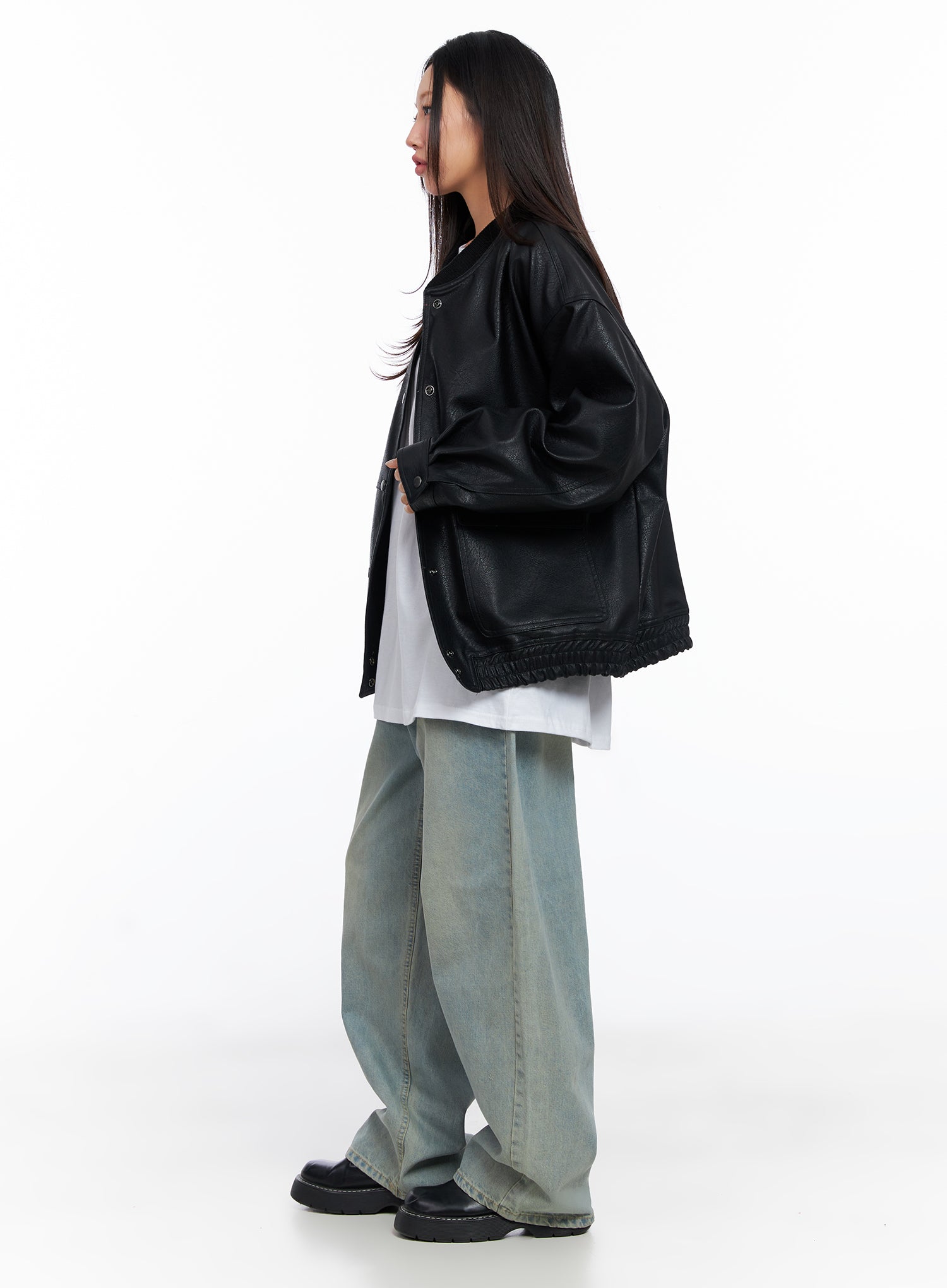 Remi Washed Baggy Jeans CO515 in light blue, side styling shot, model in black oversized leather bomber and white tee, wide-leg silhouette pooling over black loafers.
