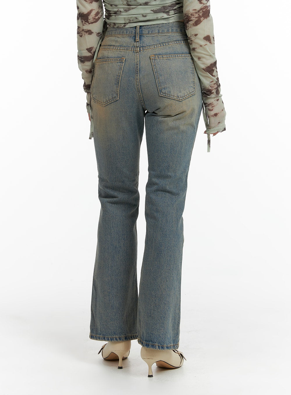 Washed Flared Jeans IF426 in blue, back close-up on model, five-pocket construction with twin back pockets and flared hem, washed denim with subtle distressing.