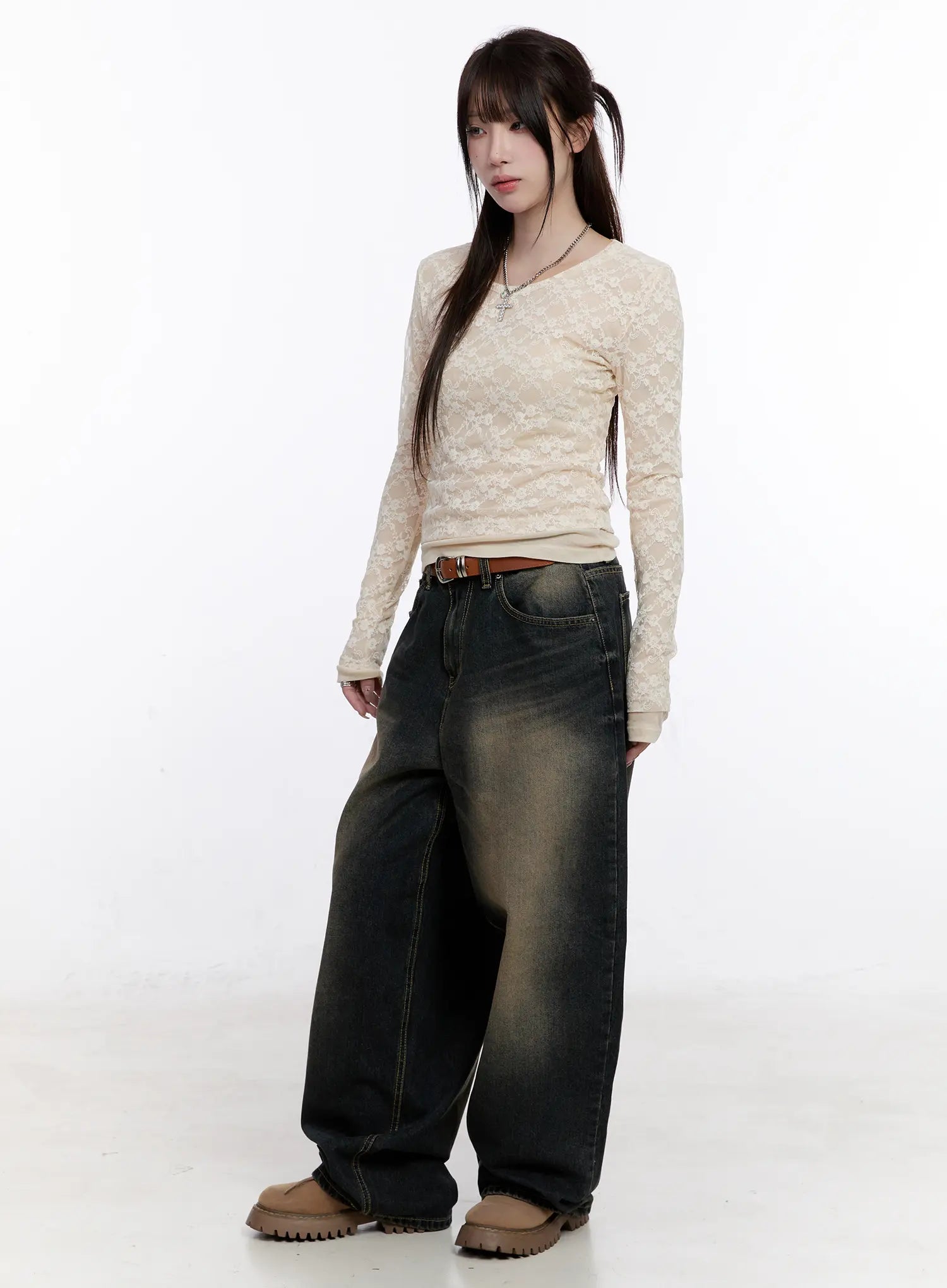 Sylvia Vintage Washed Baggy Jeans CO501 in dark blue, three-quarter front view on model, oversize baggy fit styled with cream floral lace top, brown leather belt, and chunky beige shoes.