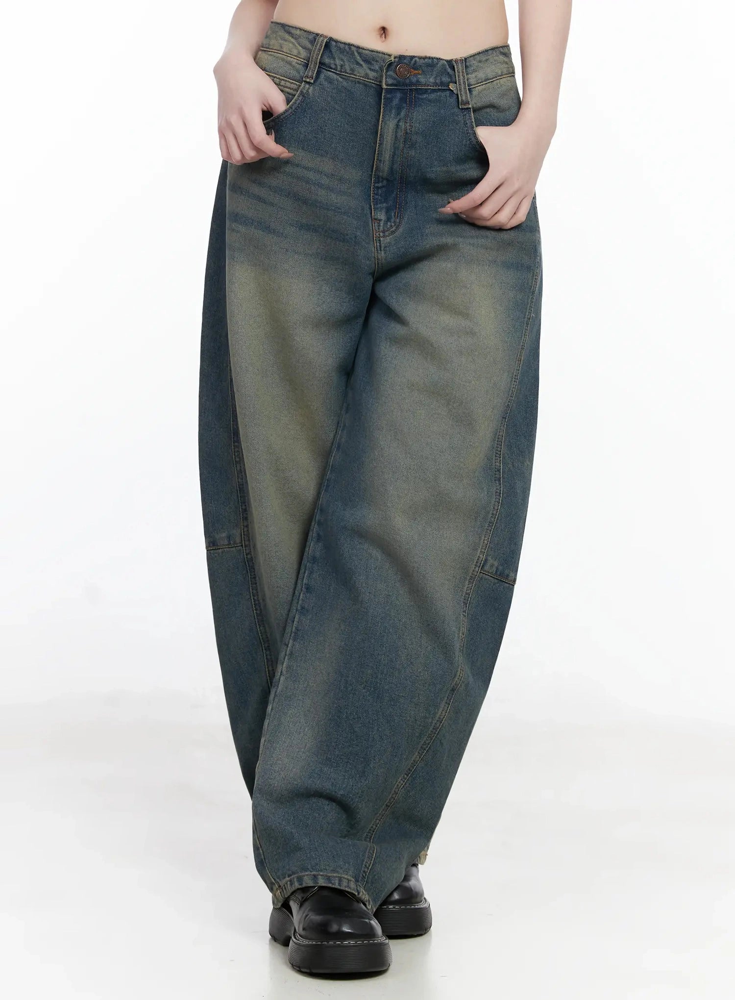 Tata Vintage Dark Blue Washed Wide Leg Jeans IJ528 in dark blue, front cropped shot from waist to ankle on model, hands in pockets, exaggerated wide leg with curved seam panel detail and vintage yellow-green washed finish.