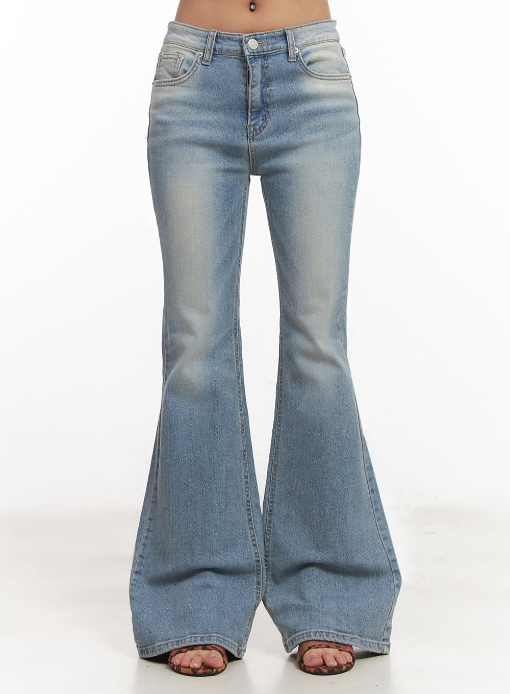 May Washed Flared Jeans IA515 in light blue, front waist-to-floor close-up on model, low-rise fit with button fly, dramatic flared leg hem, faded washed denim detailing clearly visible.