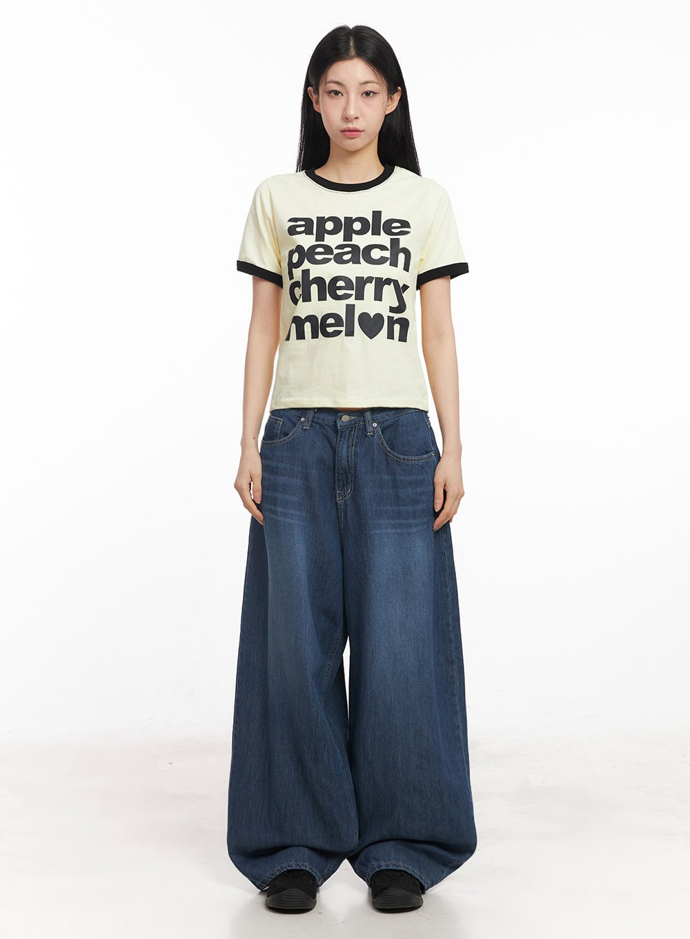 Martha Baggy Jeans IY529 in dark blue, full-body front shot on model standing straight, exaggerated wide-fit washed denim paired with yellow graphic ringer tee and black belt.