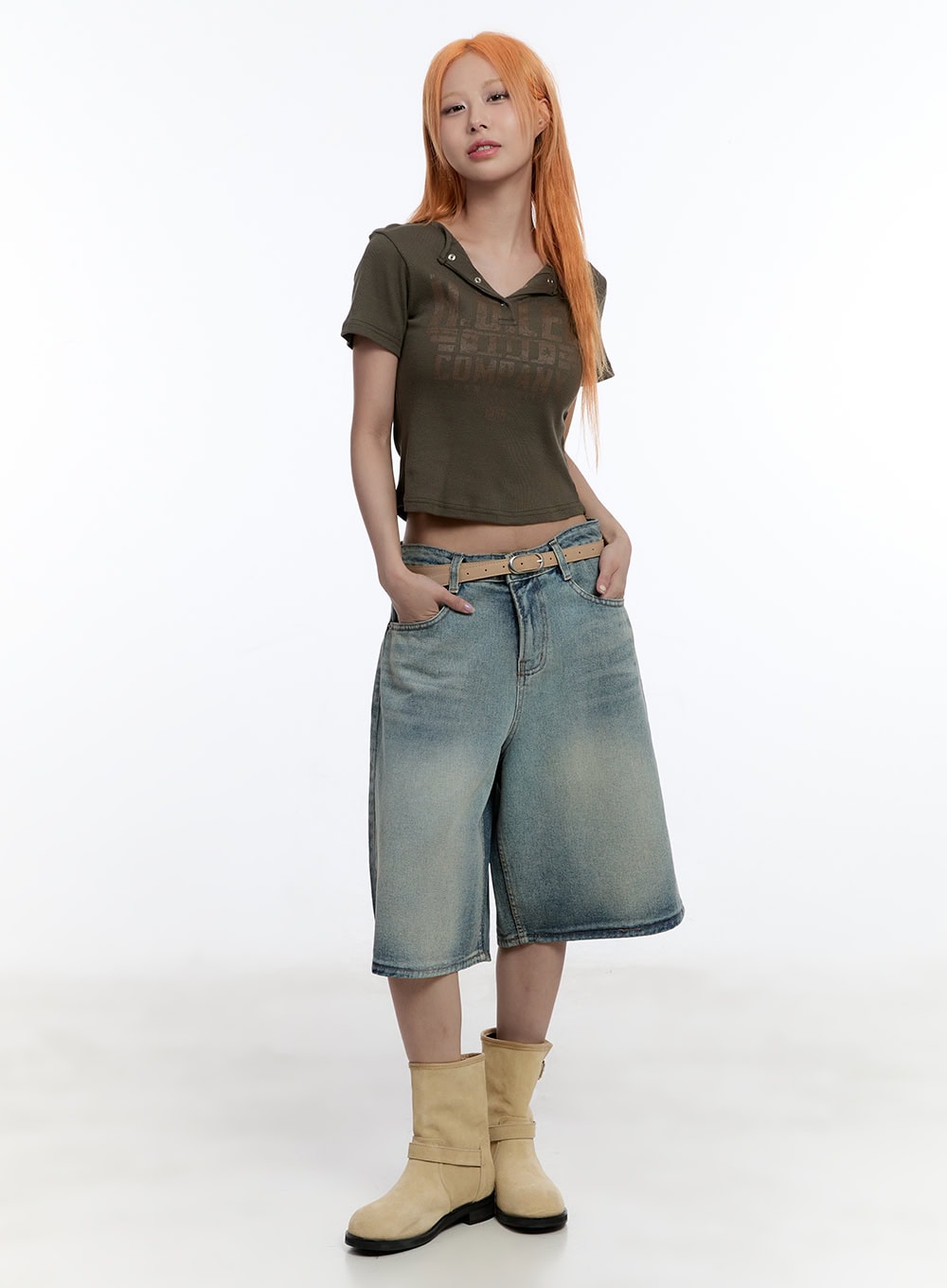 Washed Midi Baggy Jorts CY530 in blue, full-body front on model, wide-fit low-rise denim with tan belt, paired with olive crop polo tee and beige boots.