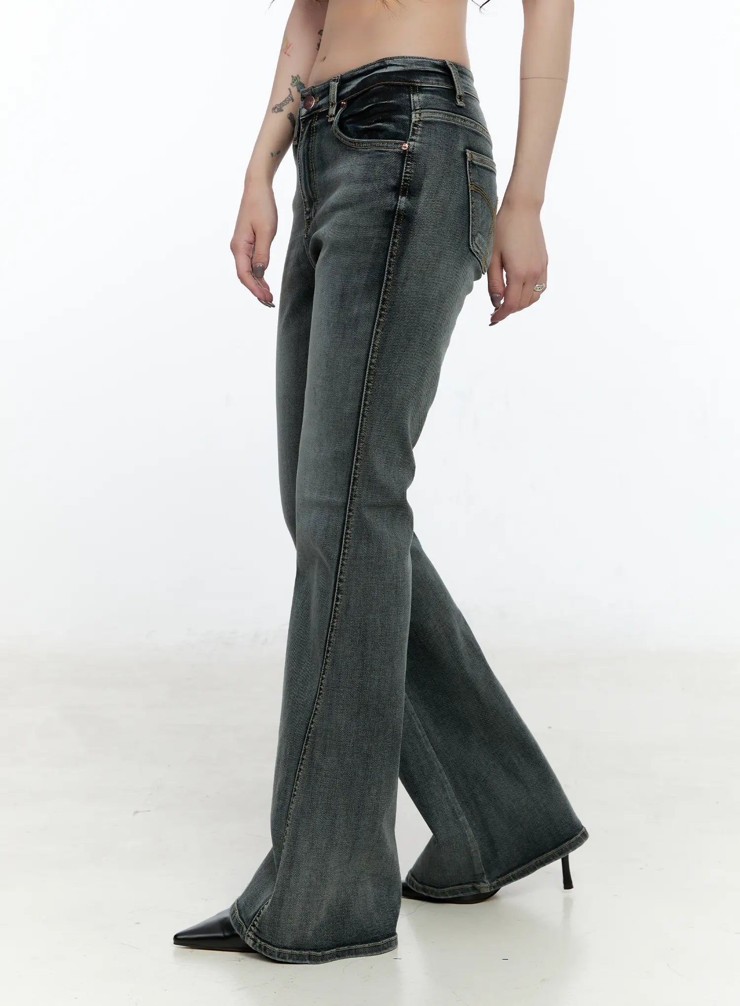 Judith Washed Bootcut Jeans CN517 in blue, side profile crop on model, highlighting mid-rise waist, side seam, and gradual bootcut flare from knee to hem, washed grey denim.