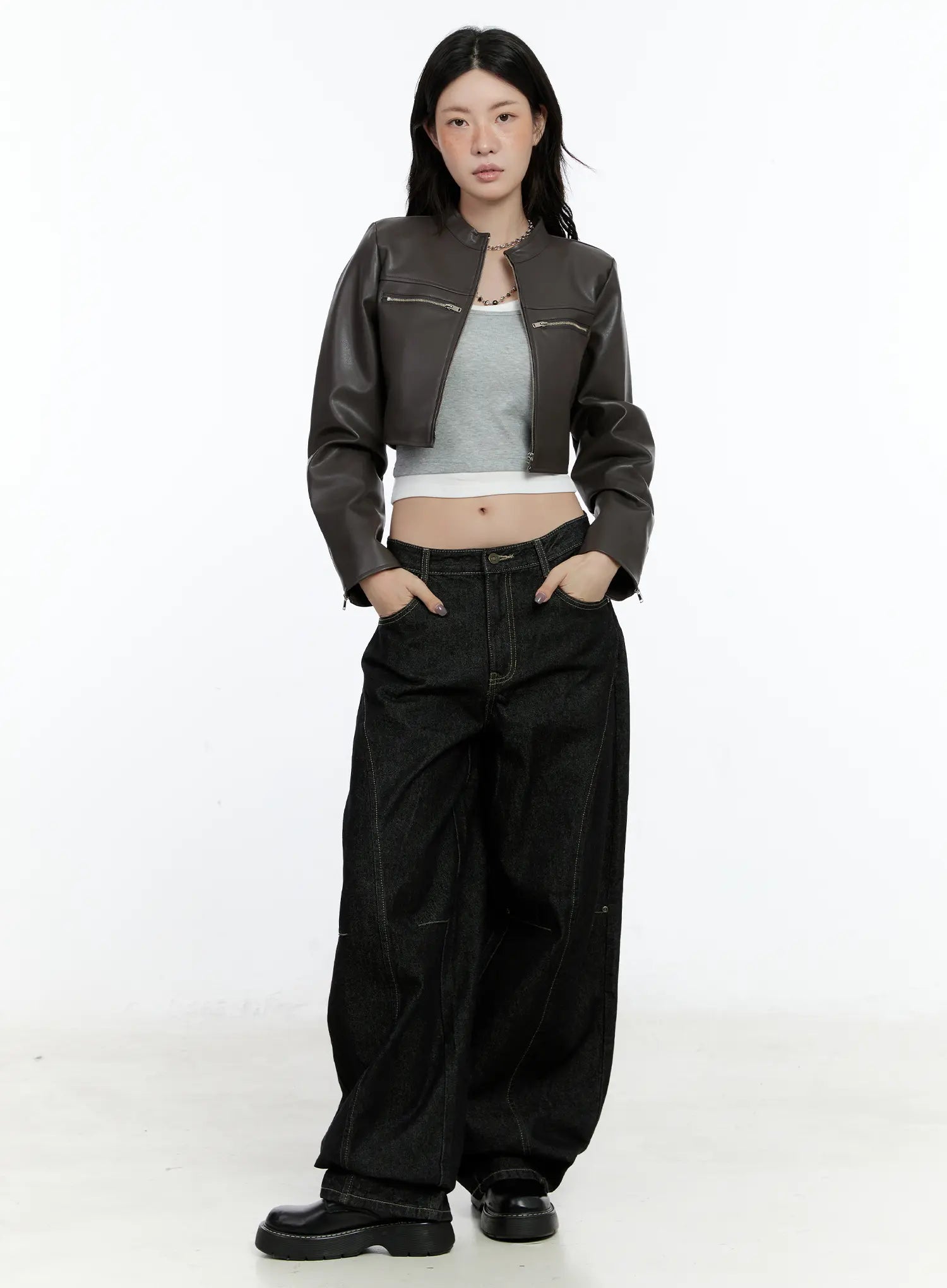 Maryam Low-Rise Dark-Washed Jeans CN517 in black, full-body front view on model, styled with brown cropped faux-leather jacket and gray tank, hands in pockets, street look.