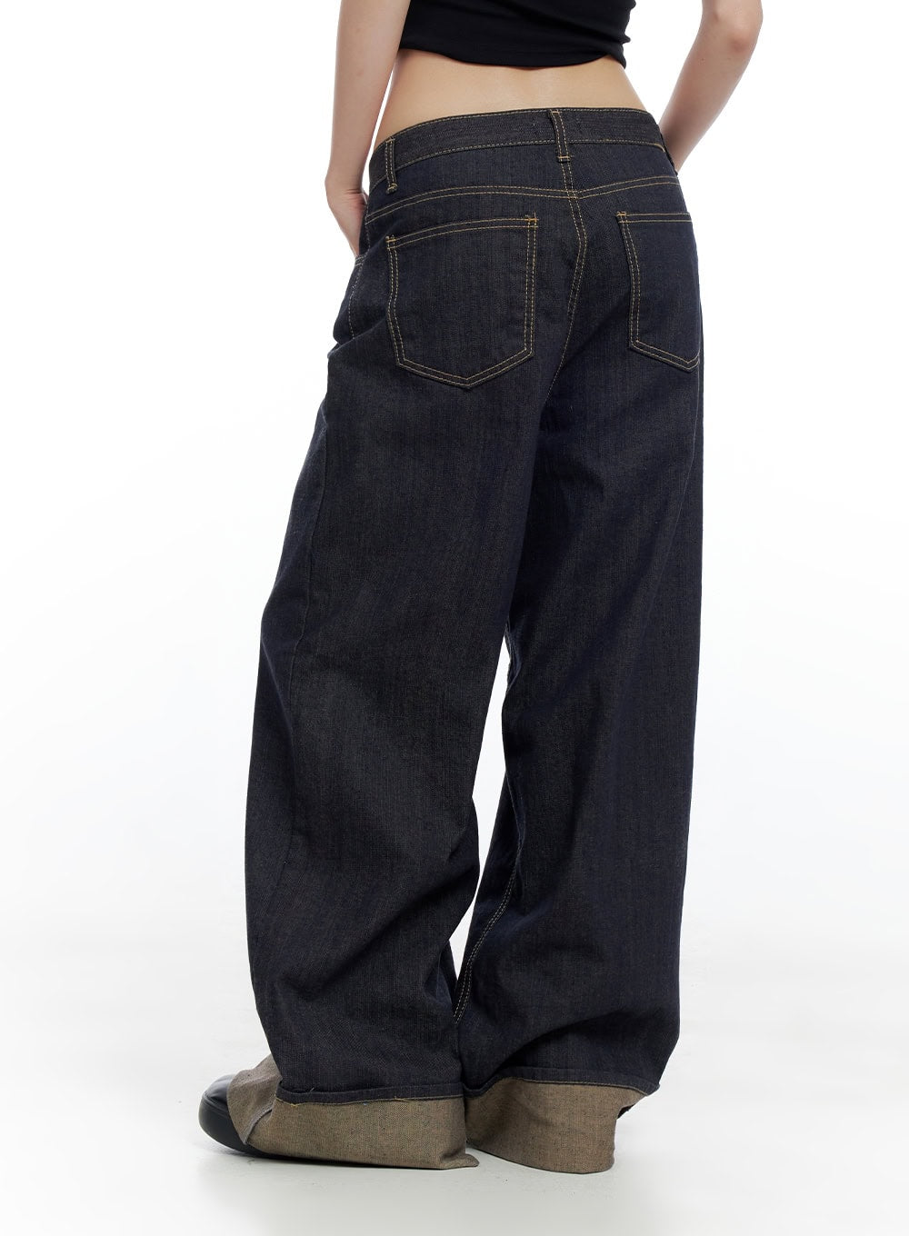 Sadie Roll-Up Denim Jeans CO426 in dark blue, back close-up on model, highlighting back patch pockets with gold contrast stitching, low-rise waistband, and contrast roll-up hem detail.