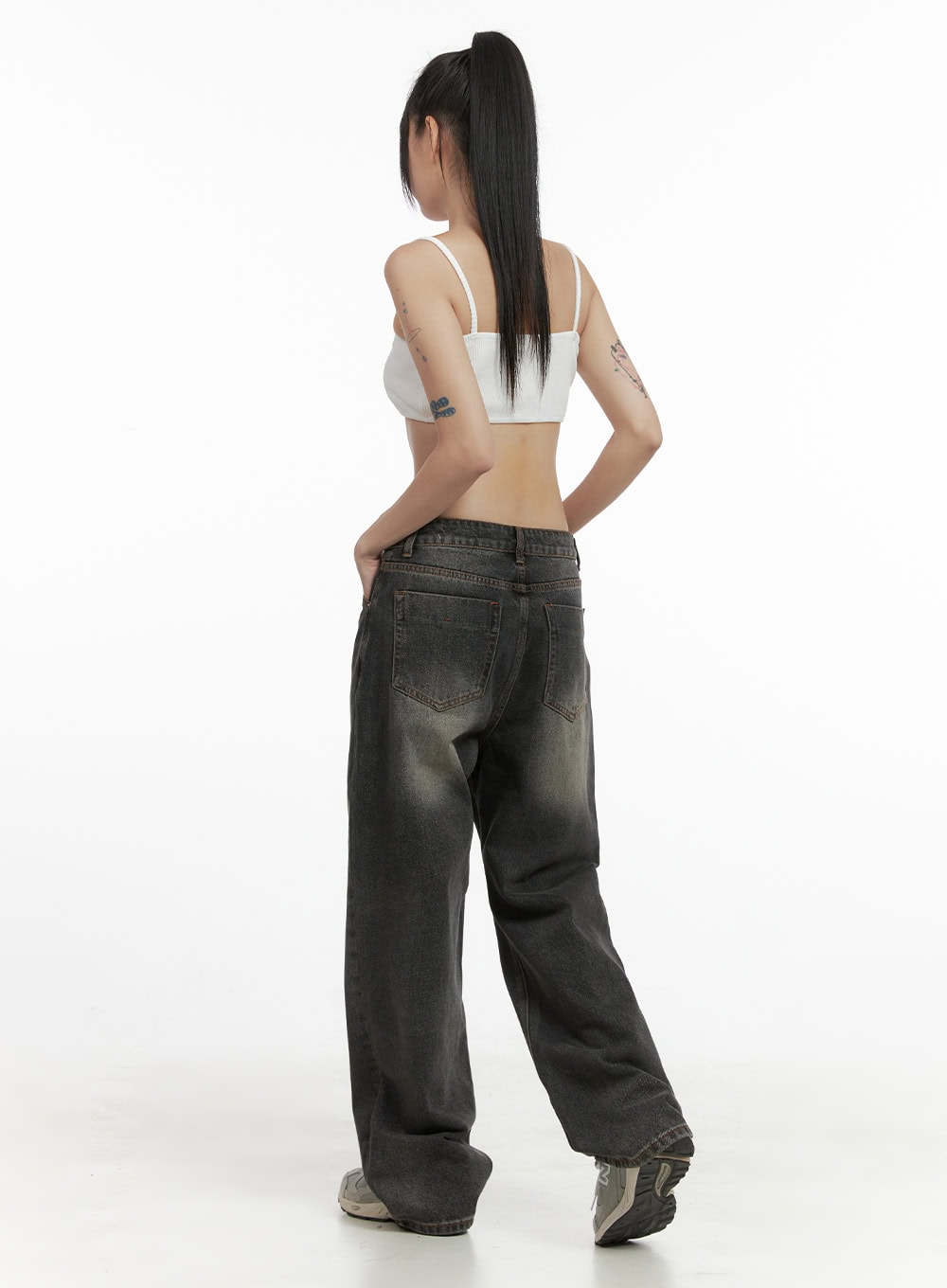 Mandy Washed Cotton Wide Leg Jeans OO401 in dark gray, back view on model, showing two back patch pockets with contrast stitching, washed faded finish, wide leg hem, paired with white crop cami.