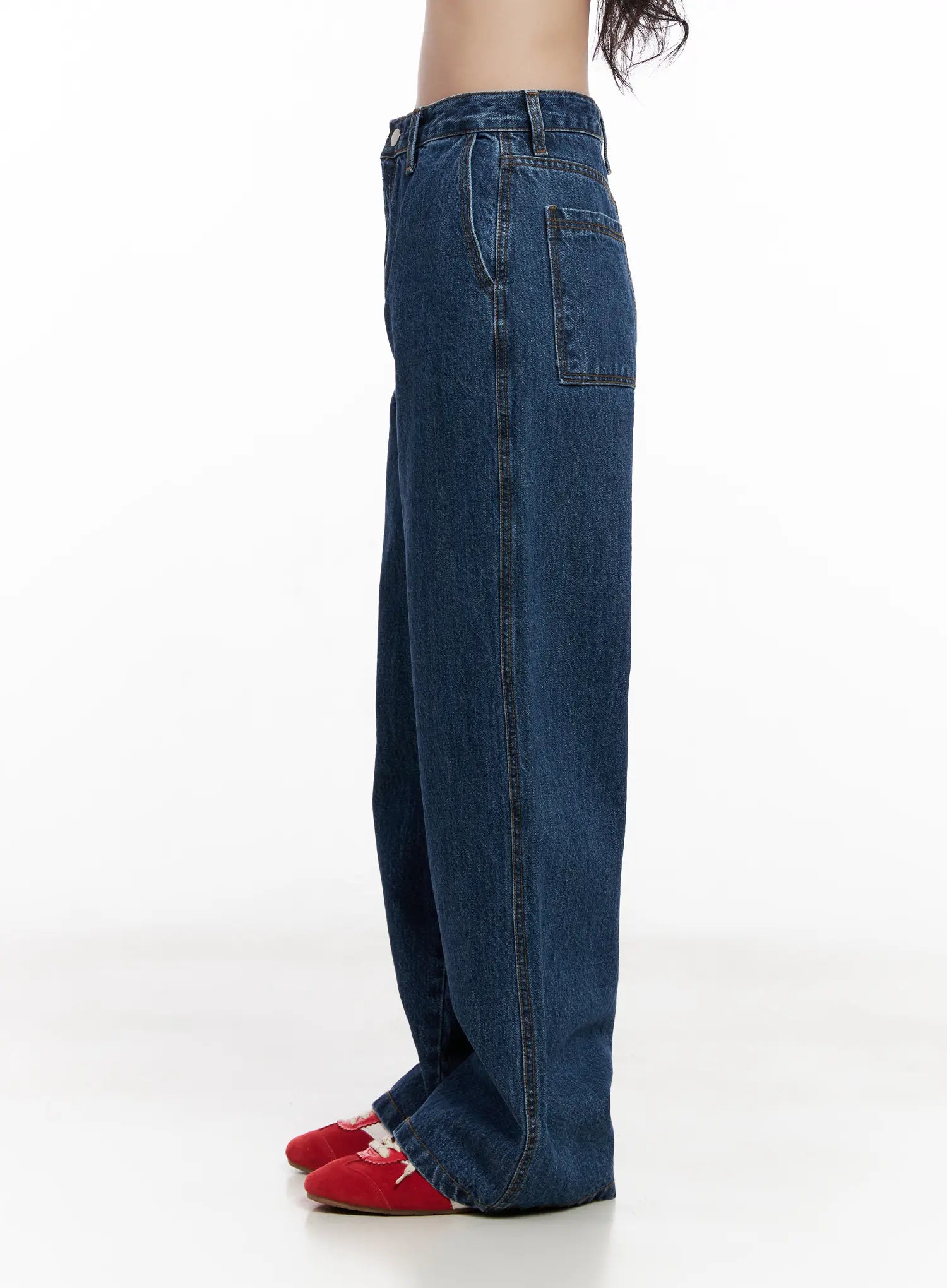 Ahyeon Classic Relaxed-Fit Denim Jeans CL515 in dark blue, close side view on model, showing patch back pocket and straight wide leg, cotton denim, red flats.