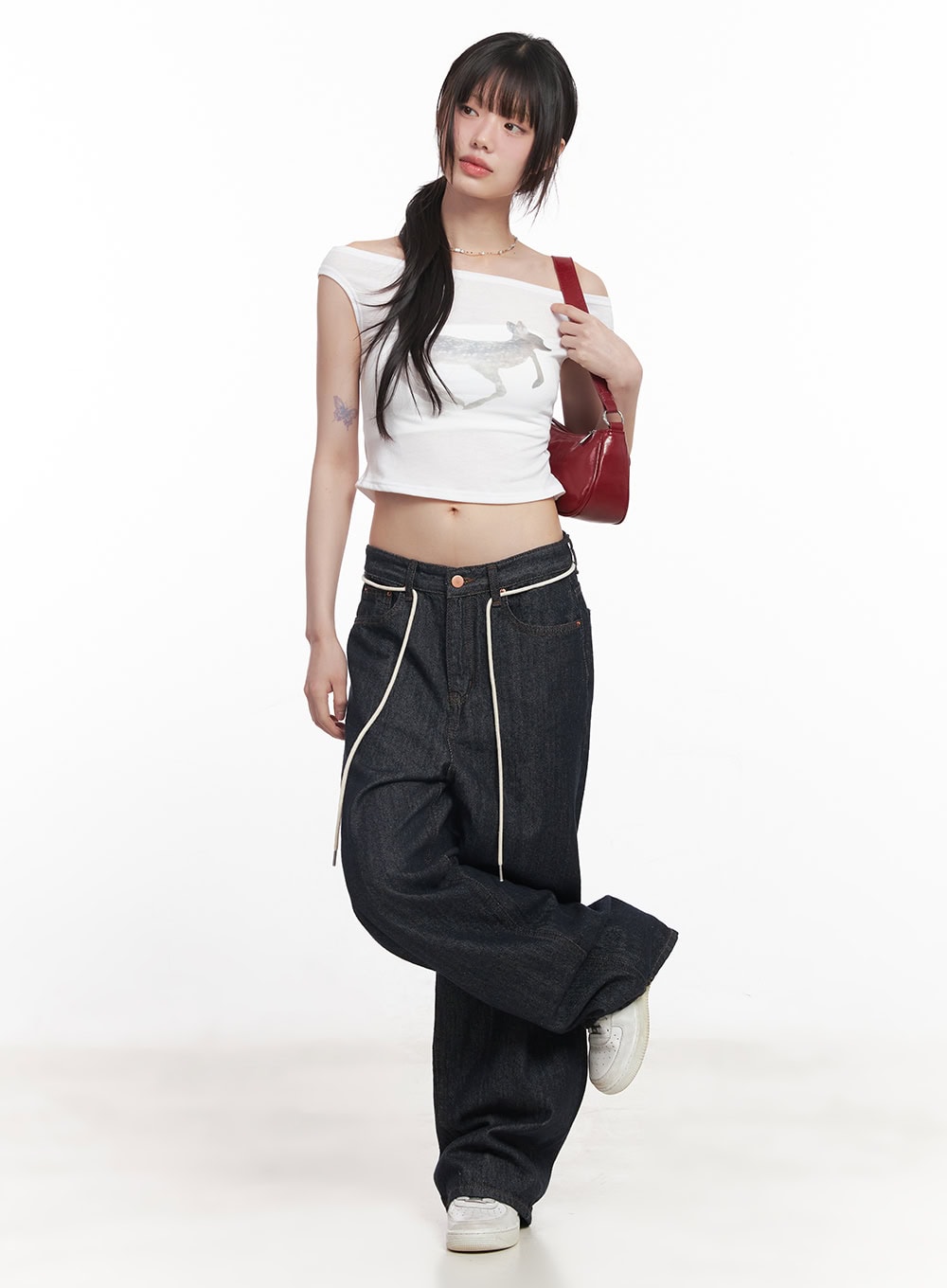 Kirsten String Wide-Leg Summer Denim Jeans IM528 in dark blue, three-quarter front view on model, cream drawstring waistband detail visible, paired with white crop top and red shoulder bag.