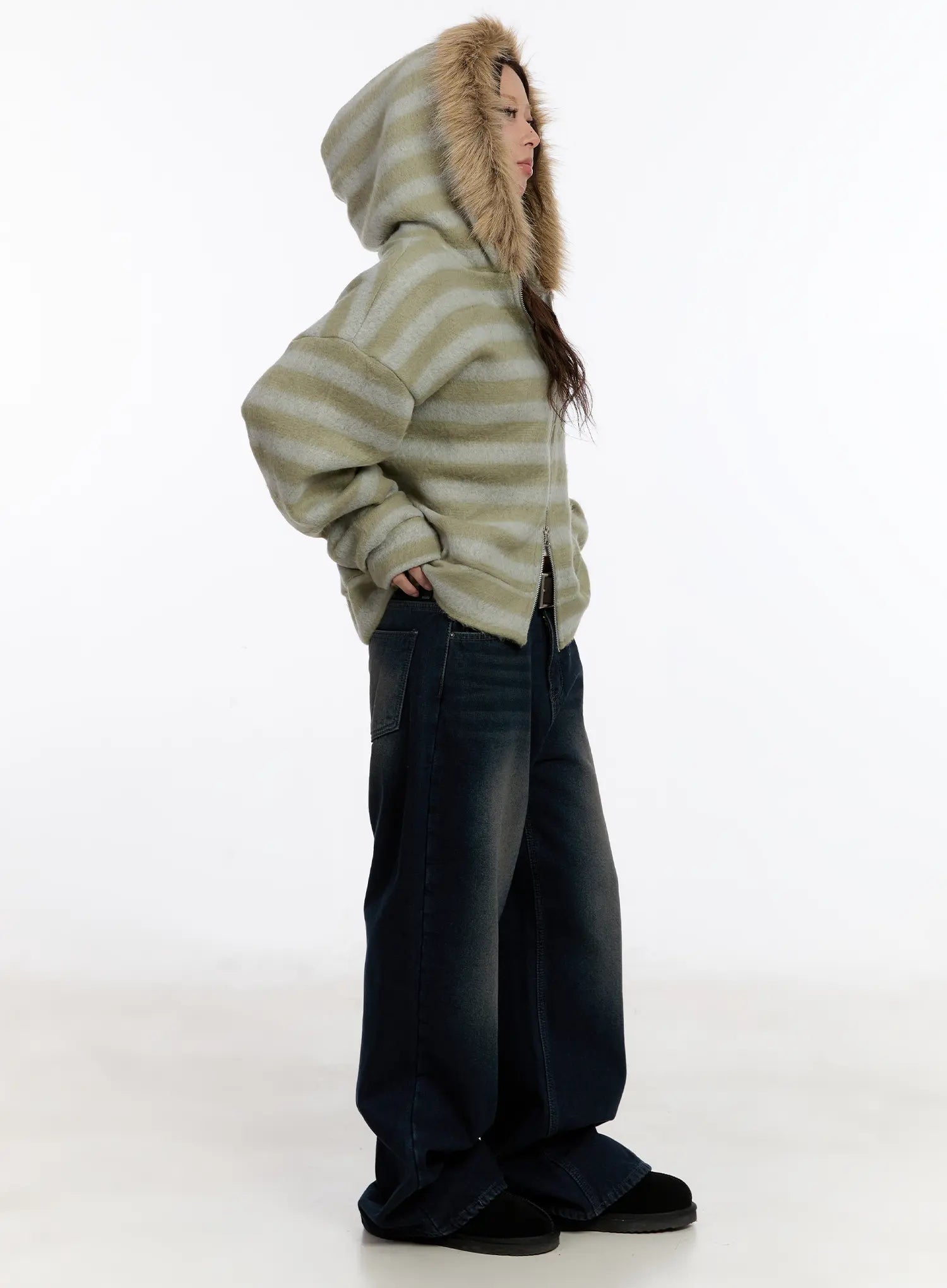 Auro Fleece-lined Wide Leg Jeans CN527 in dark blue, side profile full-length on model, low-rise wide-leg denim with washed finish, paired with striped fur-hood jacket, hands on hips.