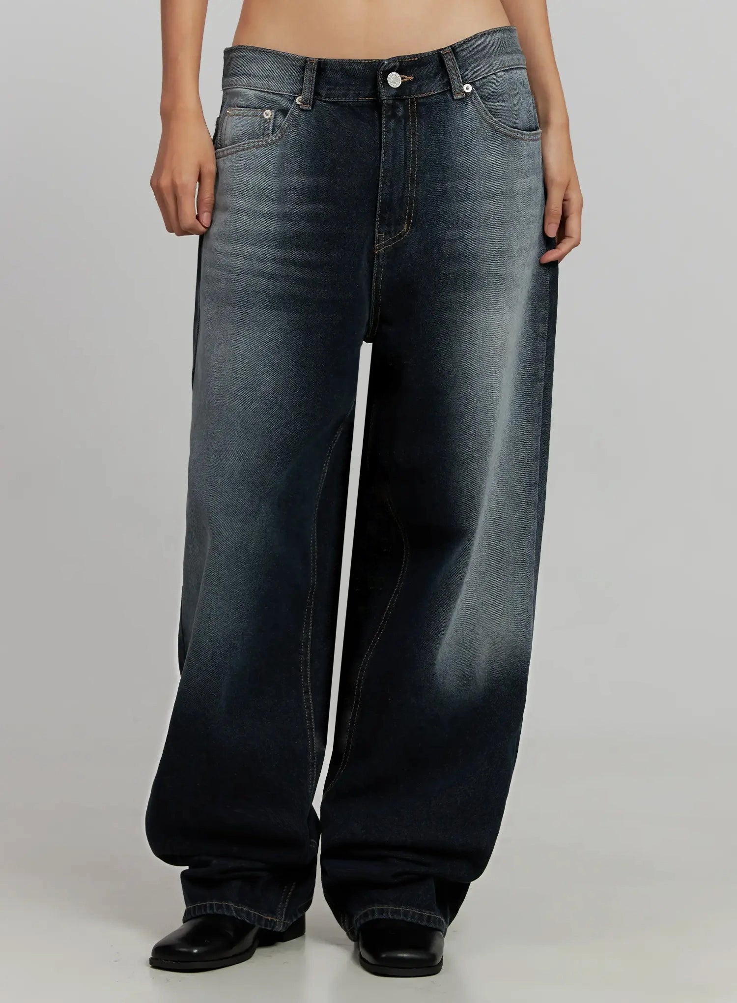 Chaya Washed Wide Jeans IJ505 in dark blue, front crop view on model, low-rise wide-leg silhouette with heavy washed fading at thighs, contrast stitching, black boots.