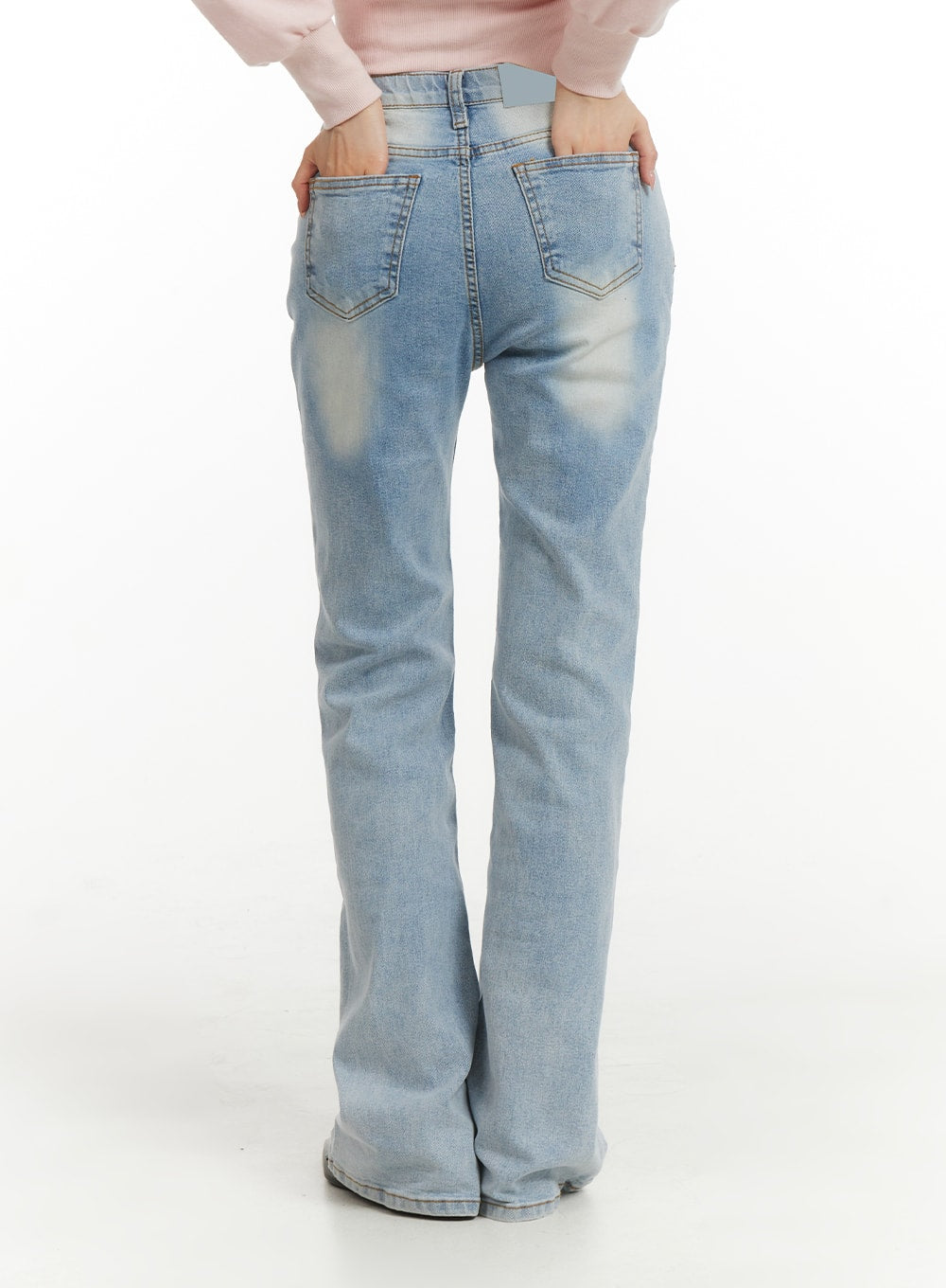 Light Washed Bootcut Jeans OF427 in light blue, back close-up on model, dual back pockets with contrast stitching, vintage washed fading across seat and thigh, slim bootcut leg.