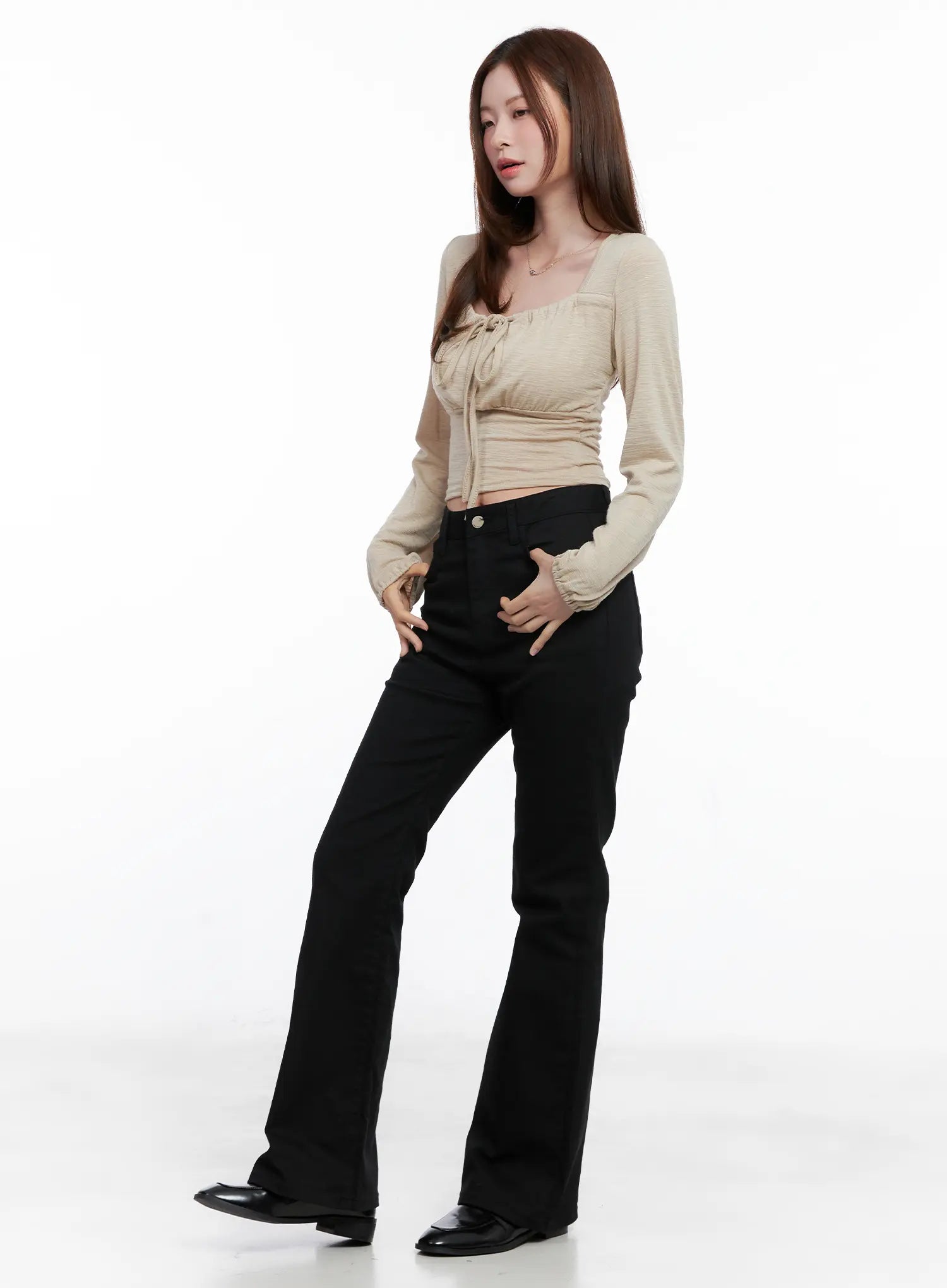 Casual Flare Cotton Pants CG521 in black, three-quarter front angle on model, paired with beige tie-front crop top, flare leg and high waistband visible, casual style.