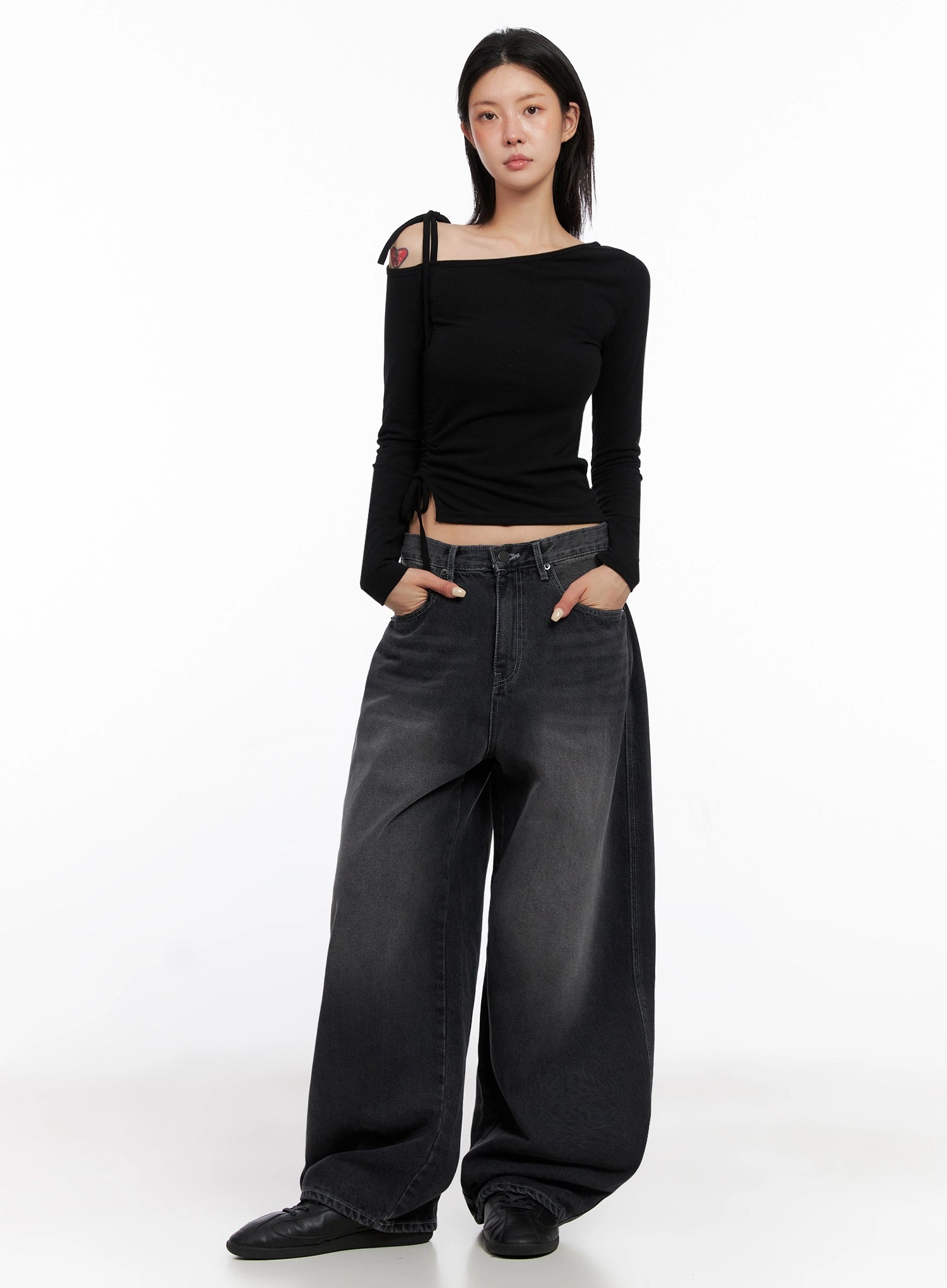 Casual Wide-Leg Baggy Jeans IS515 in Gray, full-length front on model facing camera, wide-fit washed denim with hands in pockets, paired with black asymmetric top and flats.