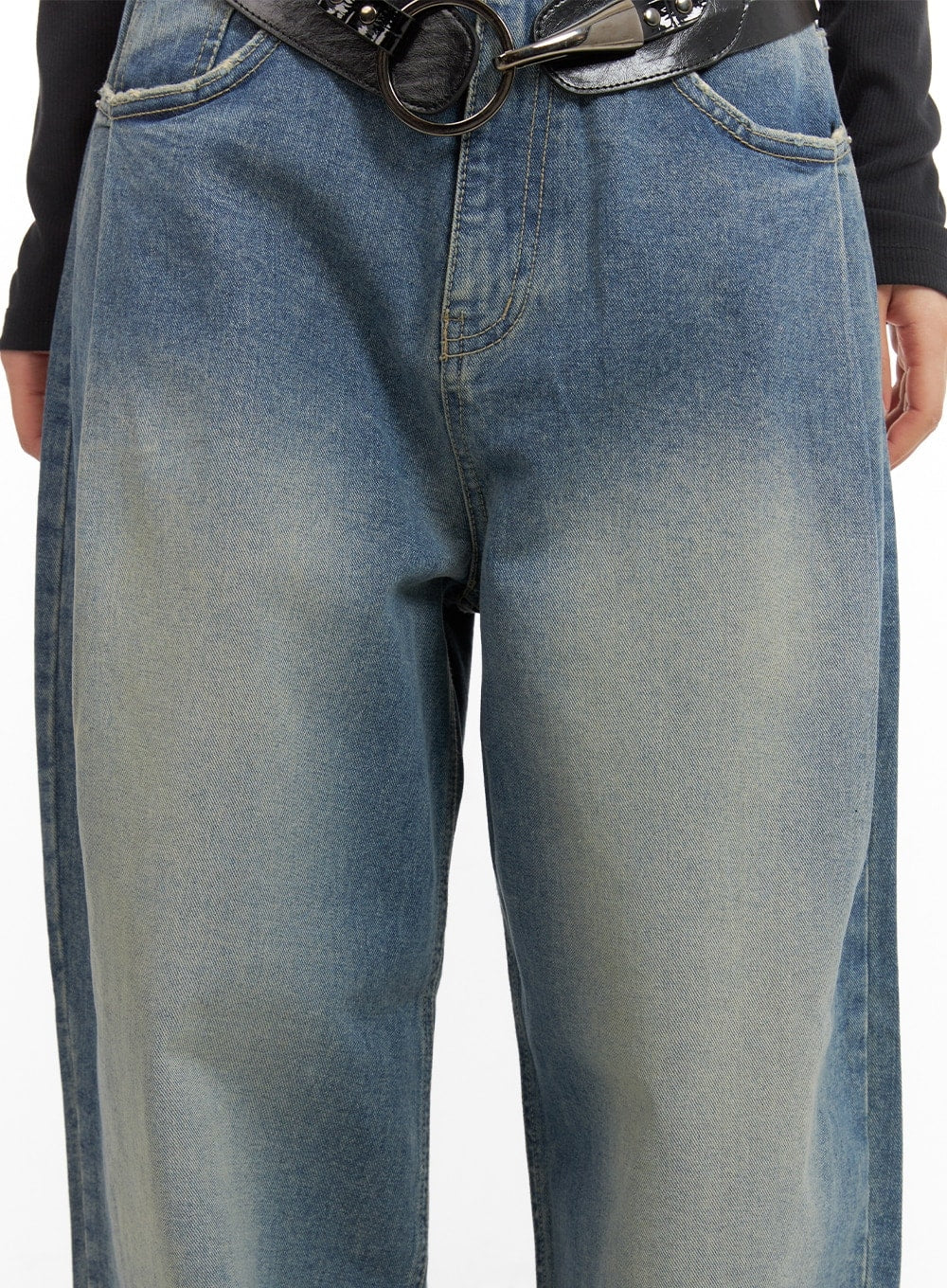 Washed Out Wide Fit Baggy Jeans CA416 in blue, front hip close-up on model, washed faded cotton denim with wide thigh, five-pocket construction and black ring belt.