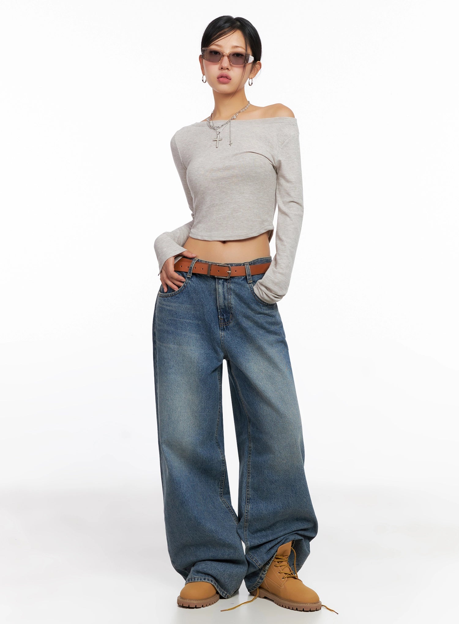 Lilah Wide-Leg Washed Jeans IG527 in mid-blue, front full-body on model with sunglasses, low-rise waist and voluminous wide leg, styled with off-shoulder top and tan boots.