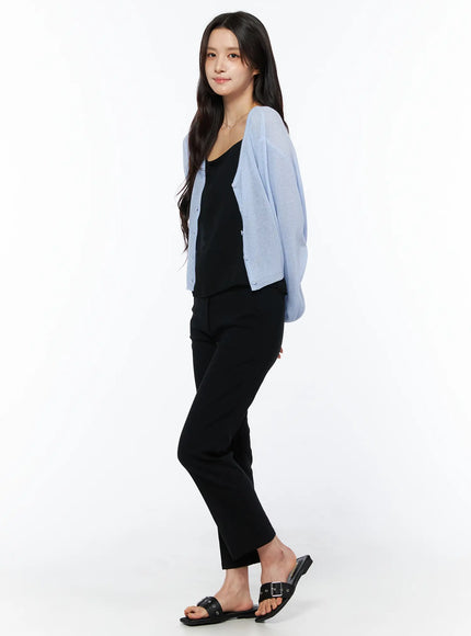 Hip-Pad Capri Pants CU522 in black, side styling shot on model, cropped straight-leg silhouette, layered with black cami and light blue oversized cardigan.