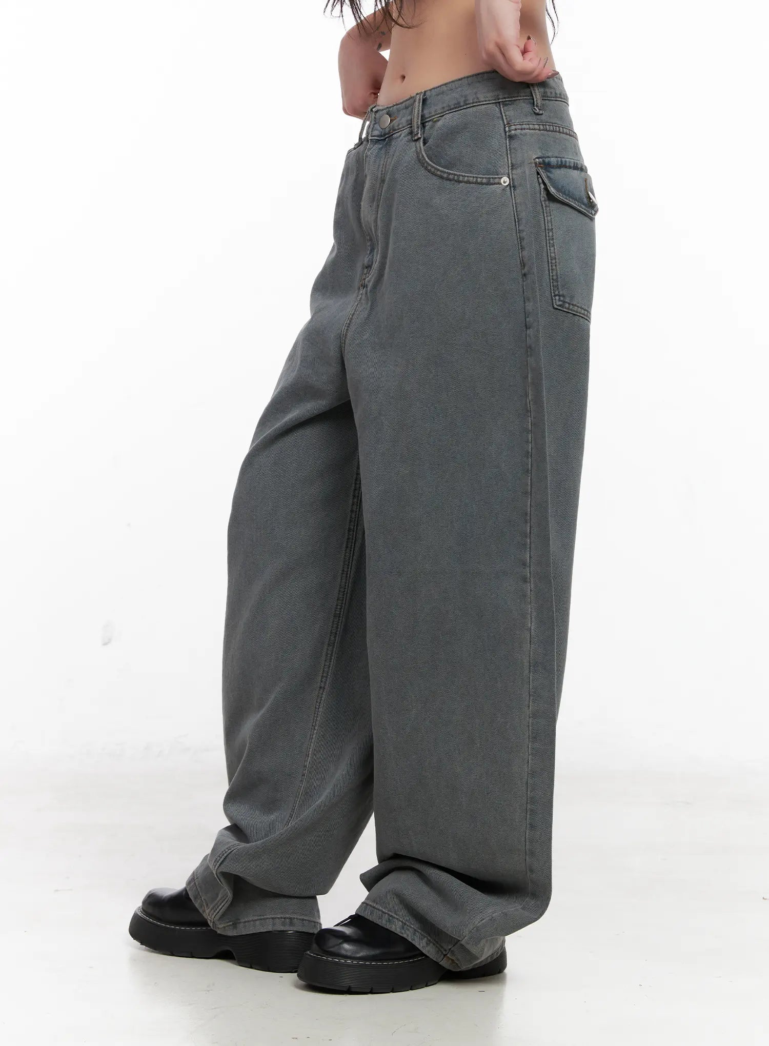 Odet Wide-Leg Balloon Jeans CN512 in blue, side close-up on model, highlighting washed cotton texture, side pocket detail, and voluminous wide-leg drape pooling at chunky loafers.