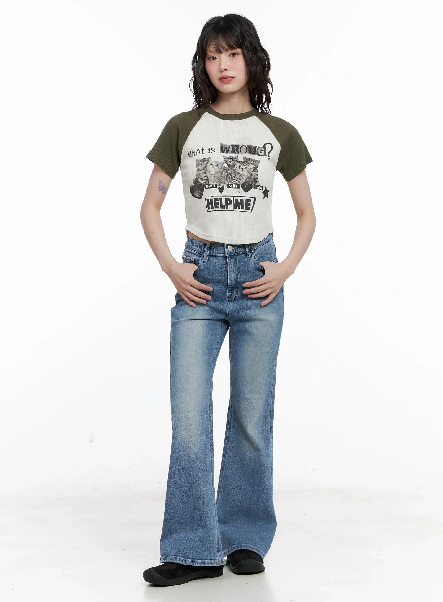 Hikaru High-Waist Flare Jeans IL531 in blue, full-length front view on model, hands on hips, washed flare silhouette with high waist, paired with cropped olive graphic raglan tee.