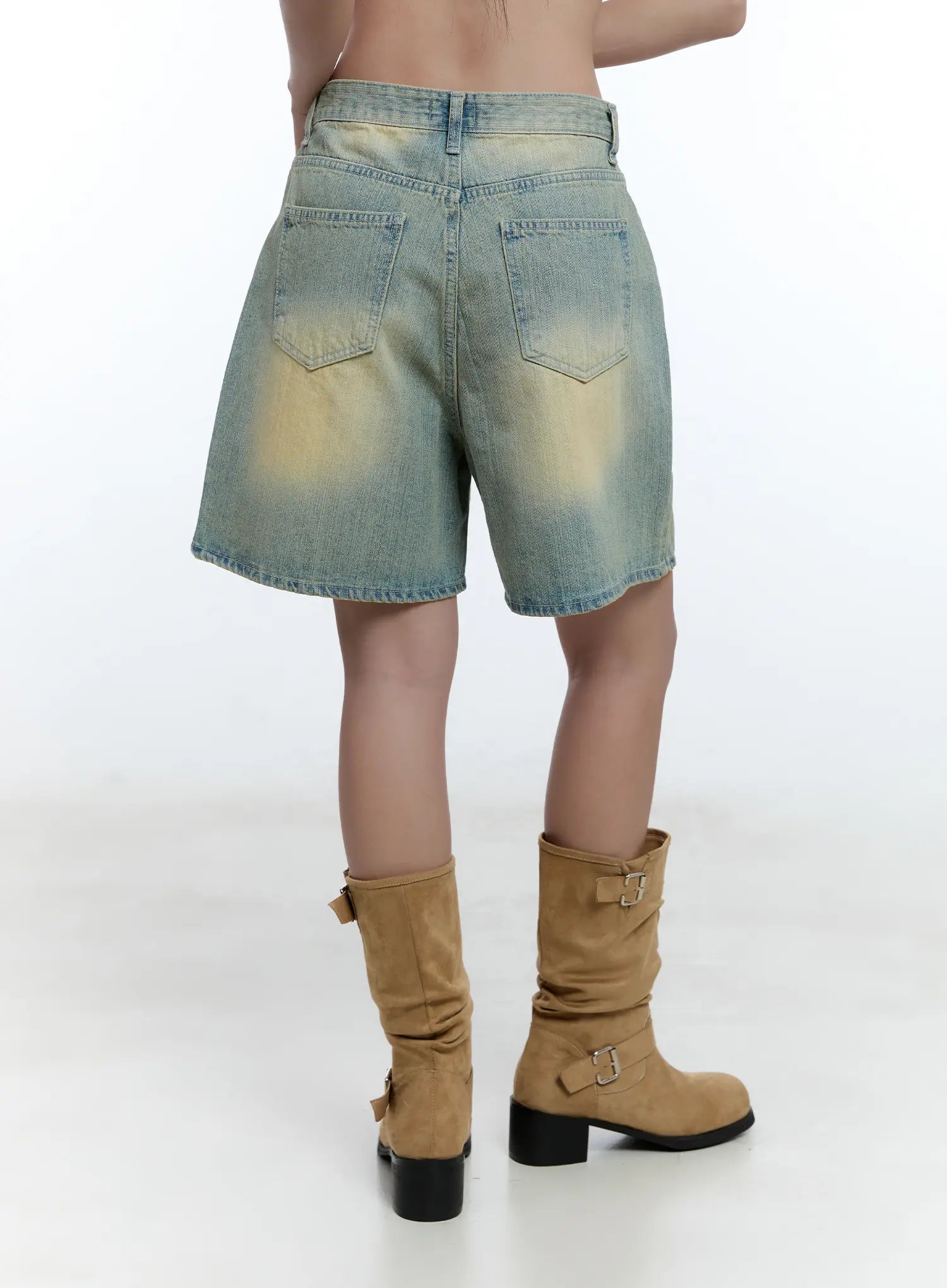 Vintage Wash Jorts CU527 in light blue, back view on model, dual back pockets with yellow-toned vintage wash detailing, styled with tan buckle boots.