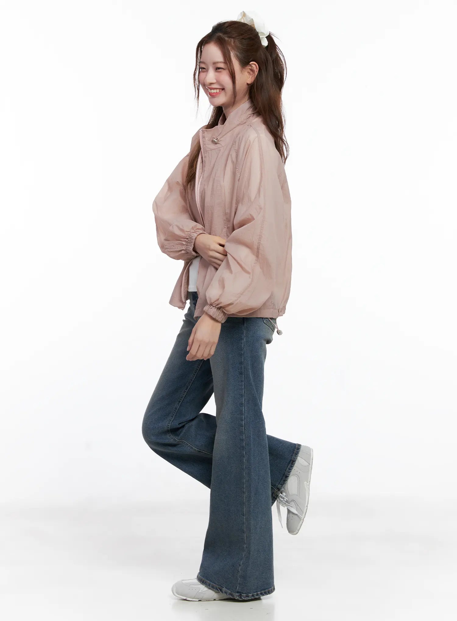 Juae High Waist Flare Jeans CG520 in blue, side full-body on smiling model, flare leg hem grazing floor, layered with pink jacket and white tee.