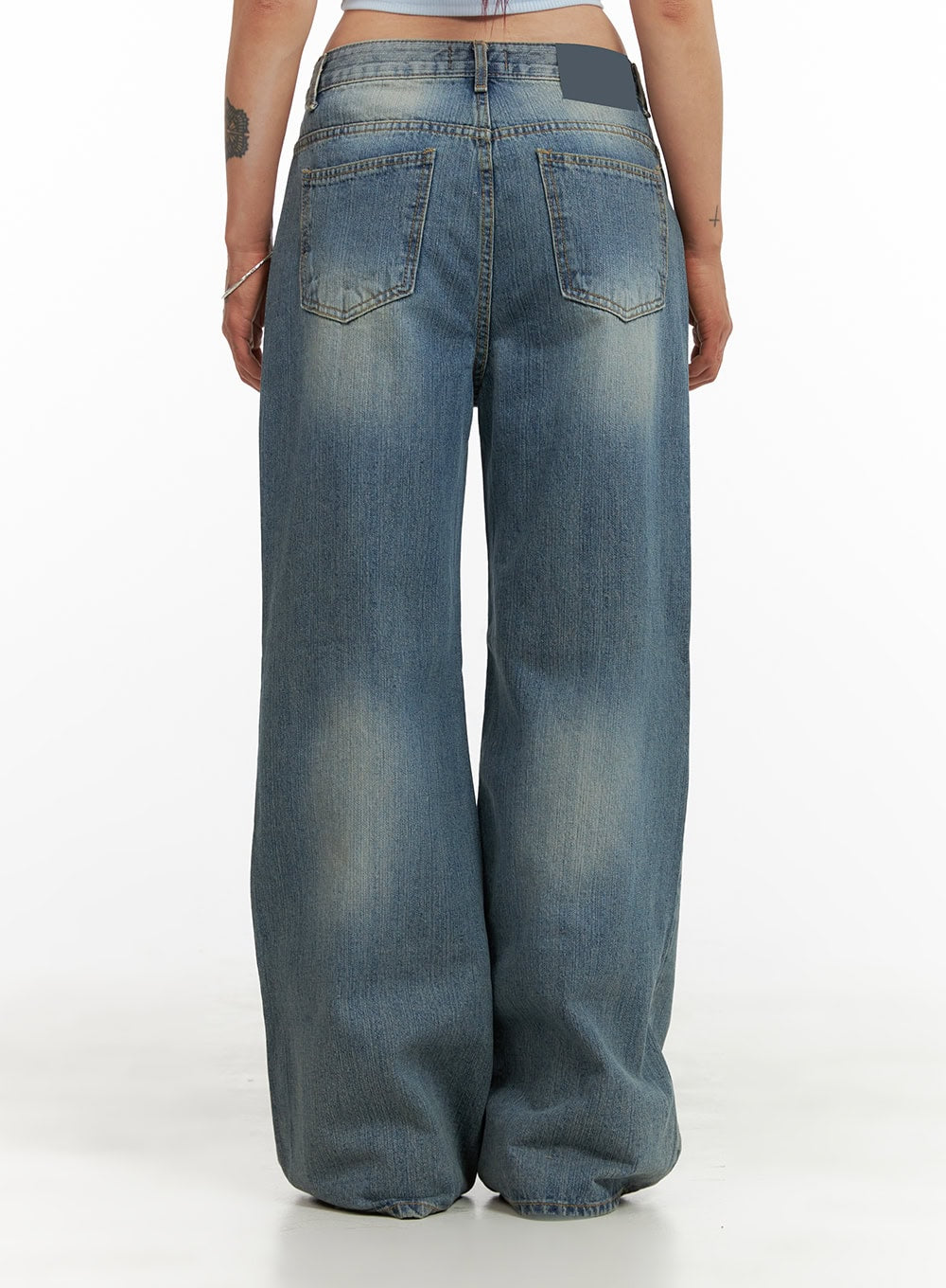 Wide Washed Denim Jeans CY429 in blue, back crop view on model, showing dual back pockets with stitching, washed fading, wide-leg cotton denim with brand label at waistband.
