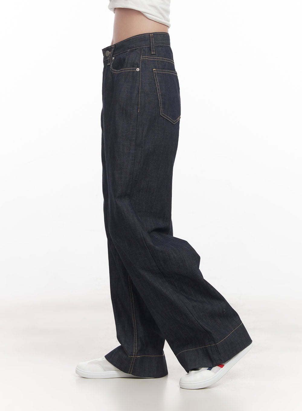 Seline Non-Fade Wide-Leg Jeans CA510 in dark blue, side close-up from waist to hem on model, showing deep side seam, contrast topstitching, and wide flared leg with cuffed hem detail.