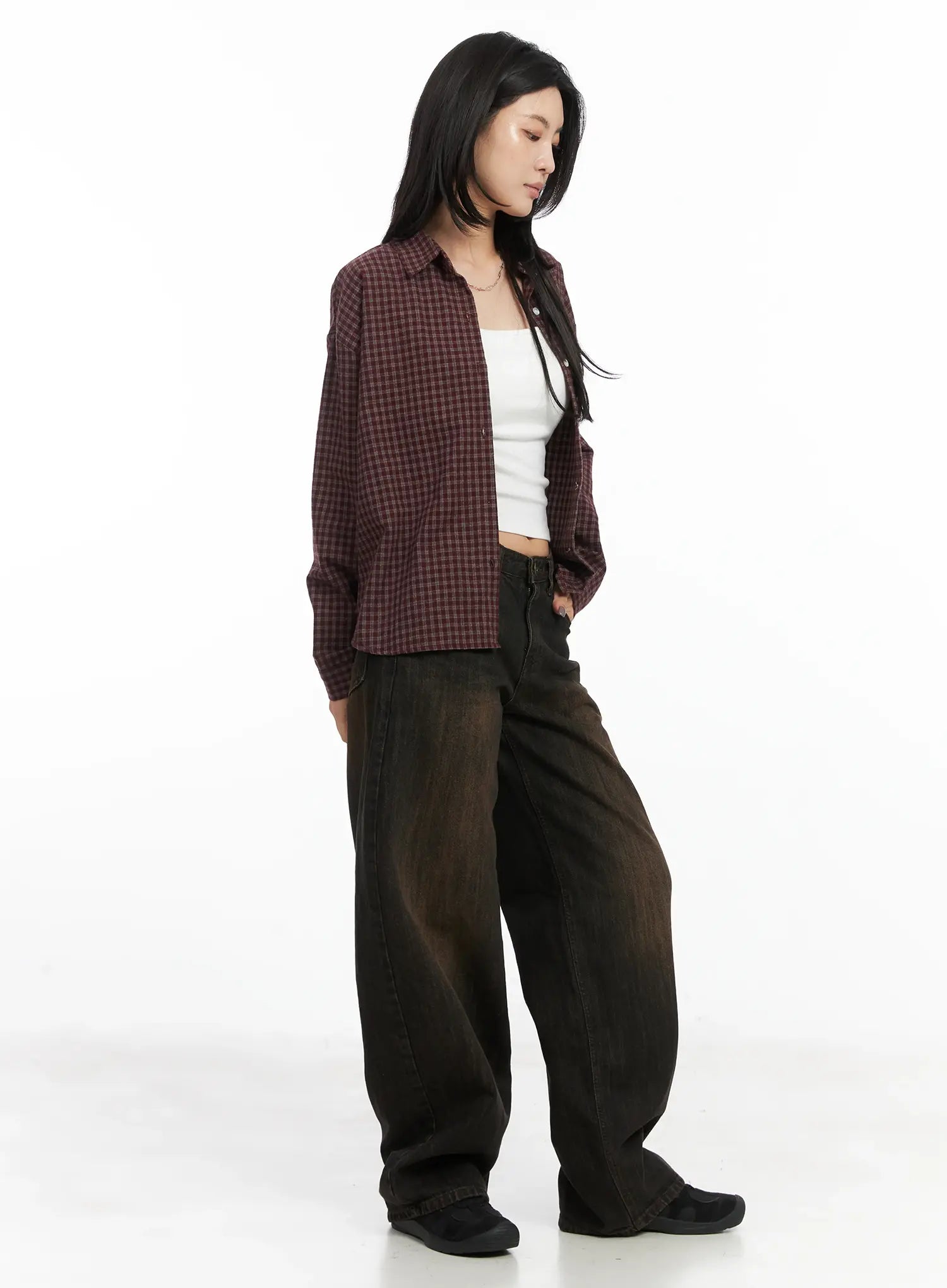 Winnie Brown Baggy Jeans CD502 in Black, three-quarter side view on model paired with plaid cropped overshirt and white tank top, showing relaxed wide-fit drape.