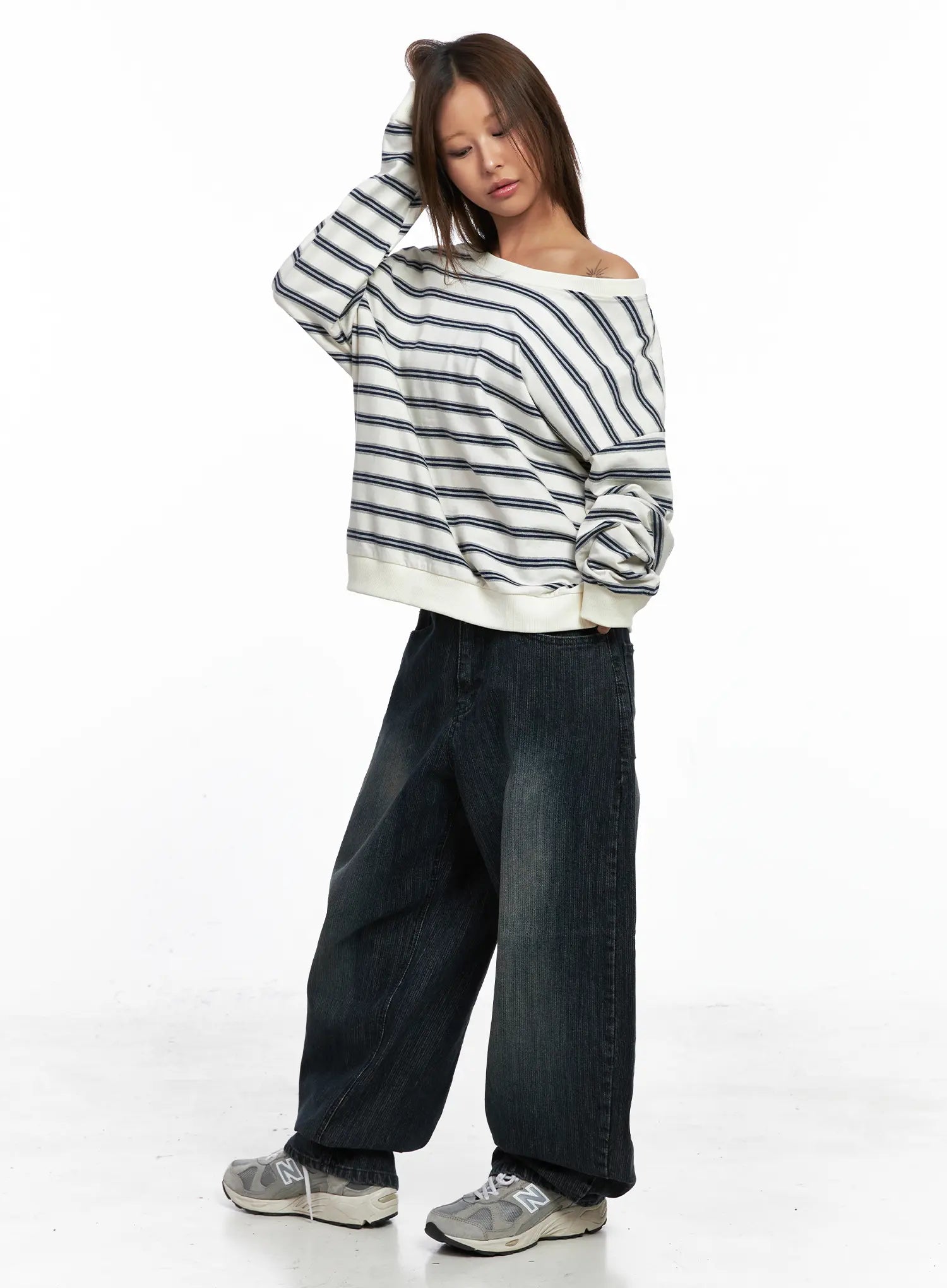 Aspyn Wide-Leg Washed Corduroy Jeans CO510 in dark blue, front full-body on model, paired with off-shoulder striped top and sneakers, relaxed wide-fit silhouette with washed finish.