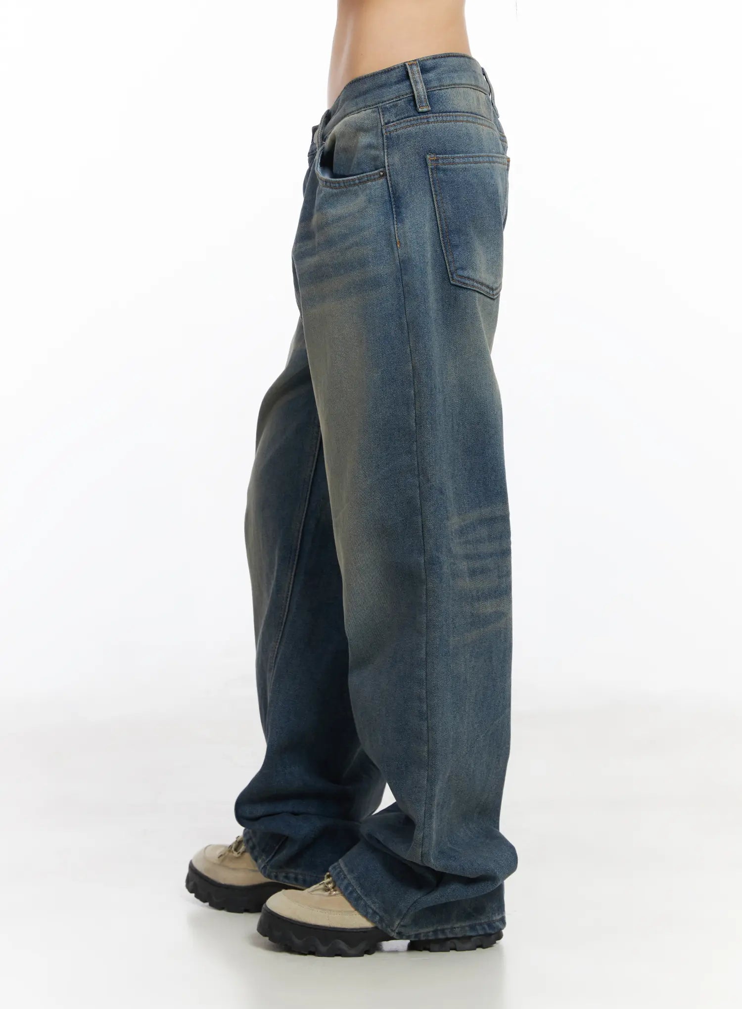 Miriam Wide Leg Jeans CD519 in blue, side close-up on model from waist to hem, washed denim with tonal fading and wide straight leg breaking over chunky sneakers.