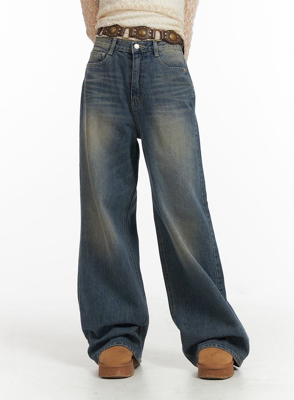 LEWKIN Wide Leg Denim Trousers CJ415 in washed blue, front close-up on model, wide-fit cotton denim with vintage fading, paired with studded belt and lace top.