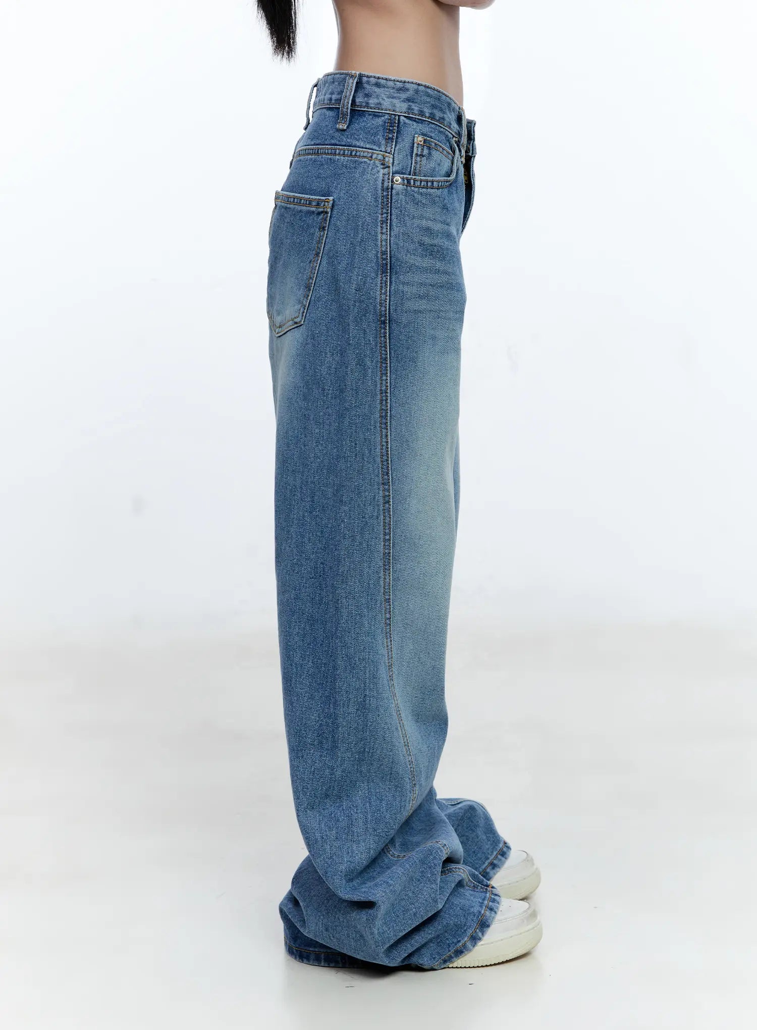 Ana Wide-Leg Denim Jeans CG507 in blue, side product shot on model from waist down, washed cotton denim with side pocket stitching and extreme wide-leg drape pooling at sneakers.