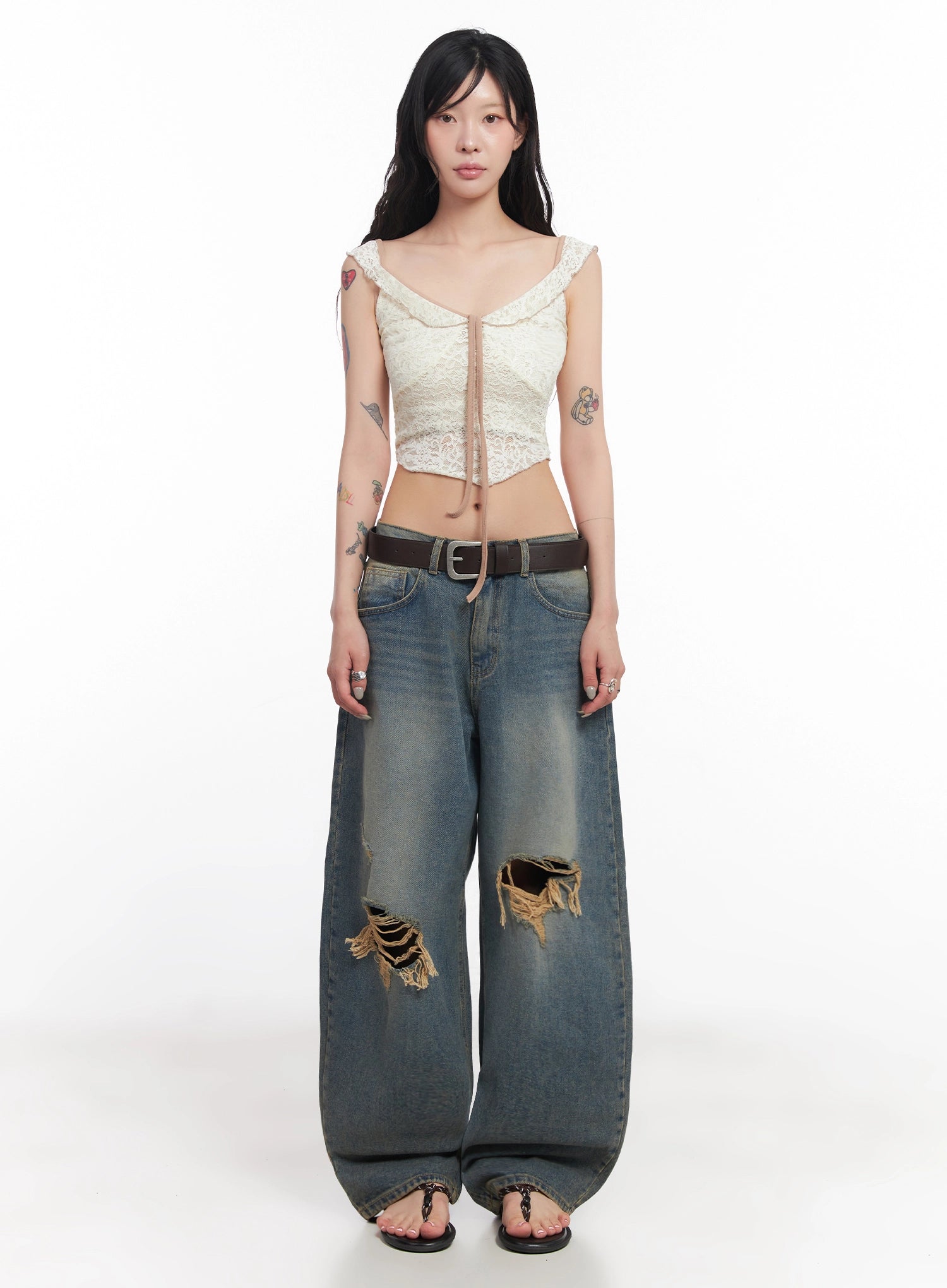 Jeemin Vintage Distressed Wide-Leg Denim Jeans IC503 in washed blue, relaxed front full-body view on model, destroyed thigh and knee tears, worn with lace corset top and brown leather belt.