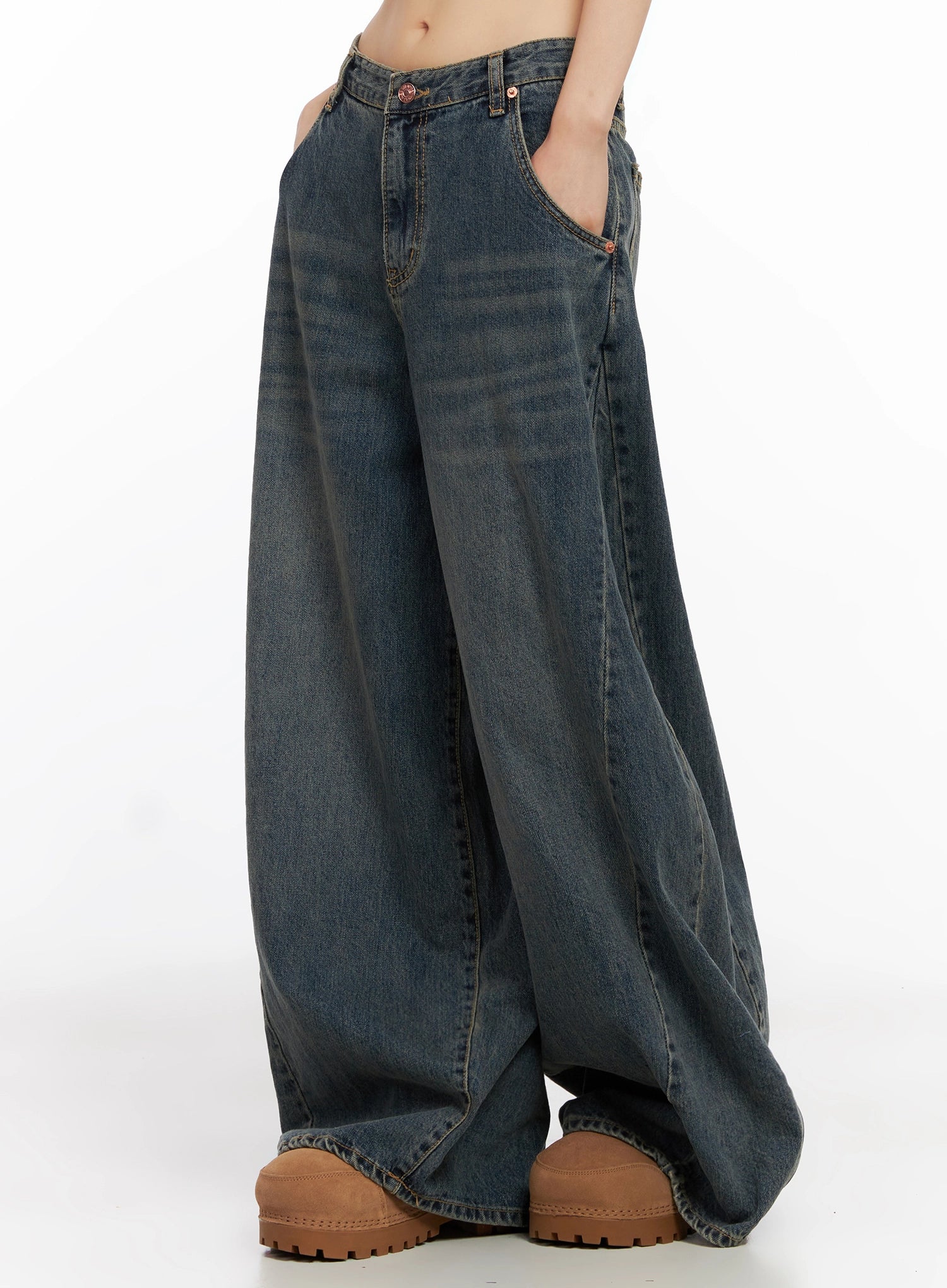 Skyler Washed Balloon Fit Jeans IN503 in blue, side close-up on model, hand in front pocket, wide balloon leg silhouette, washed cotton denim with contrast stitching detail.
