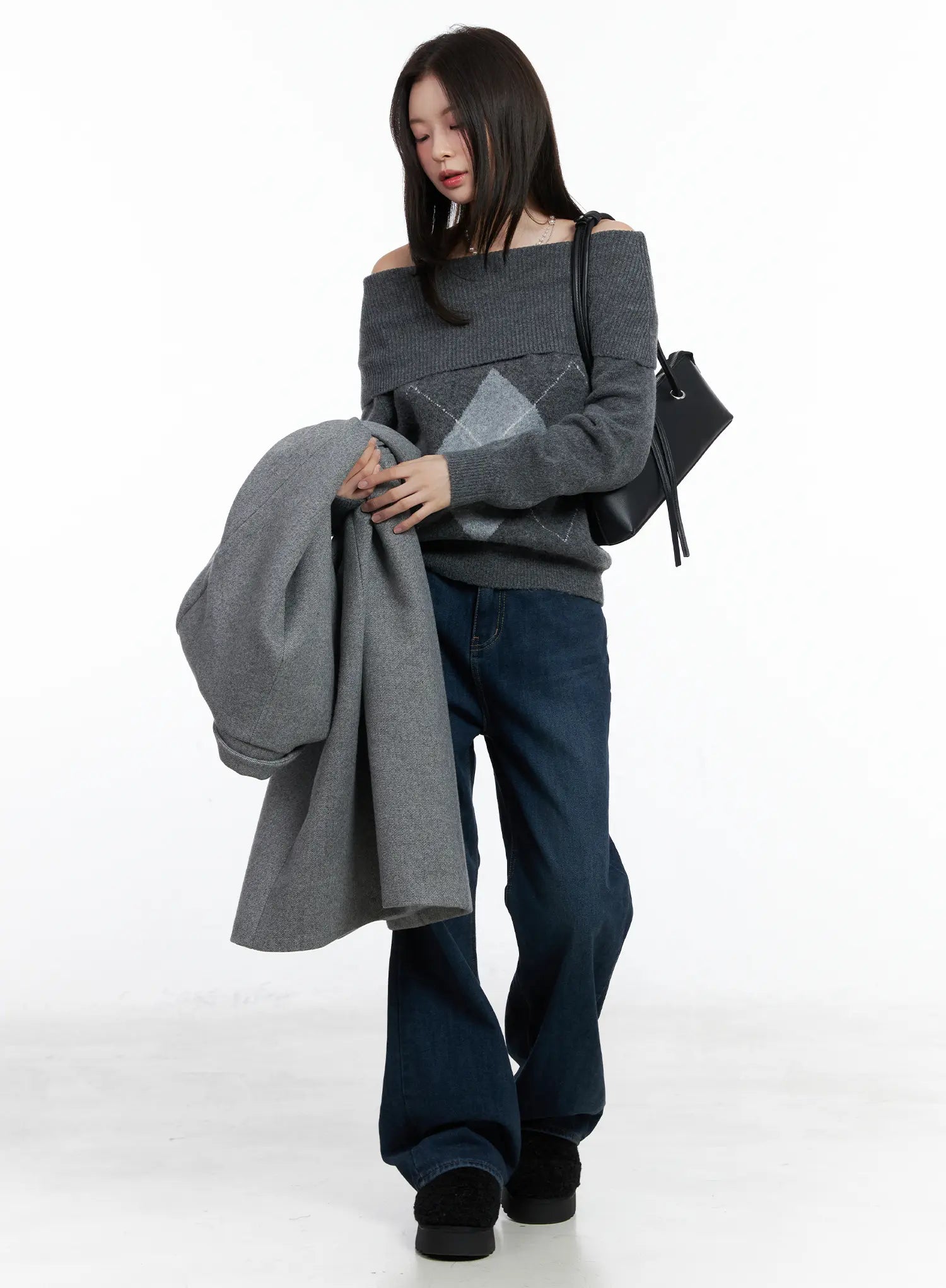 Jordan Velvet Fleece Wide Jeans CN518 in blue, three-quarter shot on model holding grey coat, styled with off-shoulder argyle knit and black bag, casual winter look.