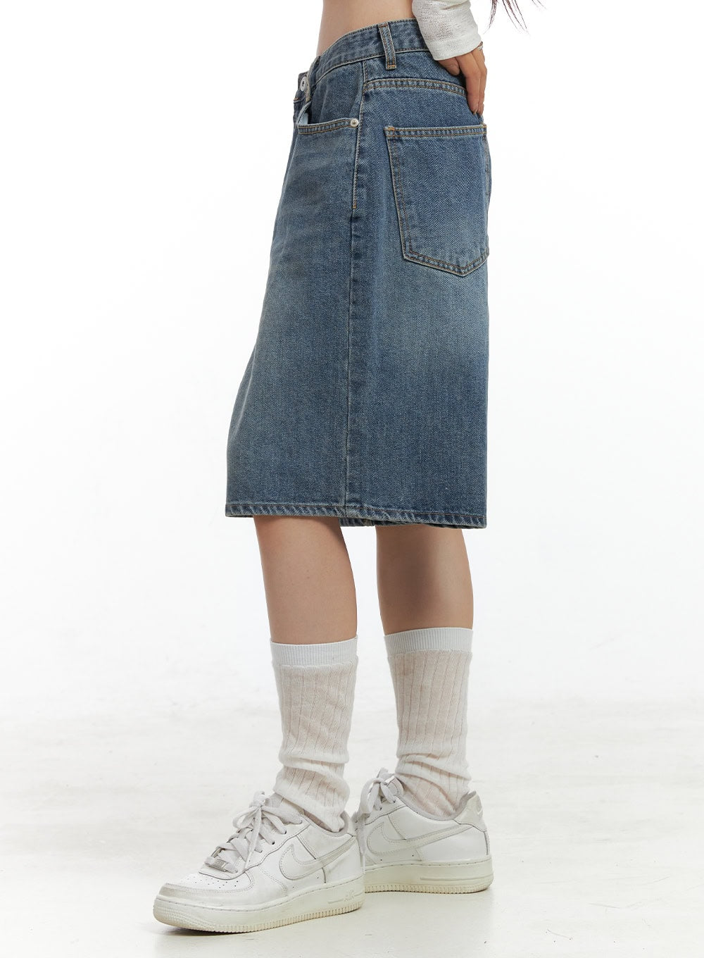Low Rise Bermuda Jorts CL424 in blue, side close-up from waist to hem, wide-leg bermuda silhouette in washed cotton denim, back pocket and stitch detail visible, worn with white sneakers.
