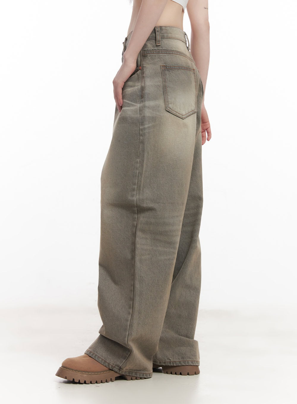 Joey Washed Wide-Leg Jeans CM528 in gray, side close-up from waist to hem on model, highlighting back pocket stitching, sun-faded washed texture, and extreme wide-leg volume, paired with tan chunky boots.