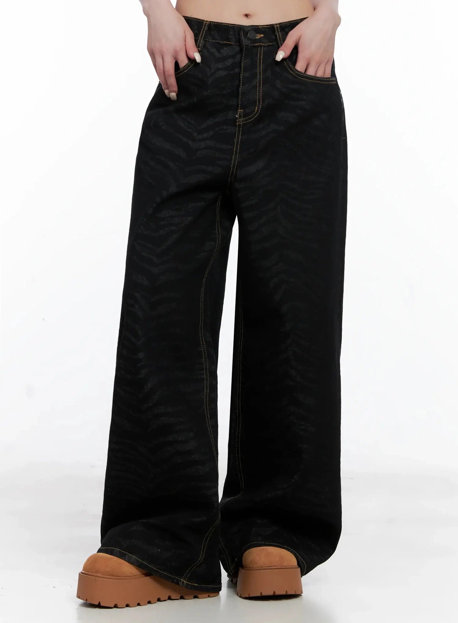 Freyja Animal Print Wide Leg Jeans IS508 in black, front mid-shot on model, wide-leg silhouette with zebra jacquard and gold contrast stitching, hands in pockets.