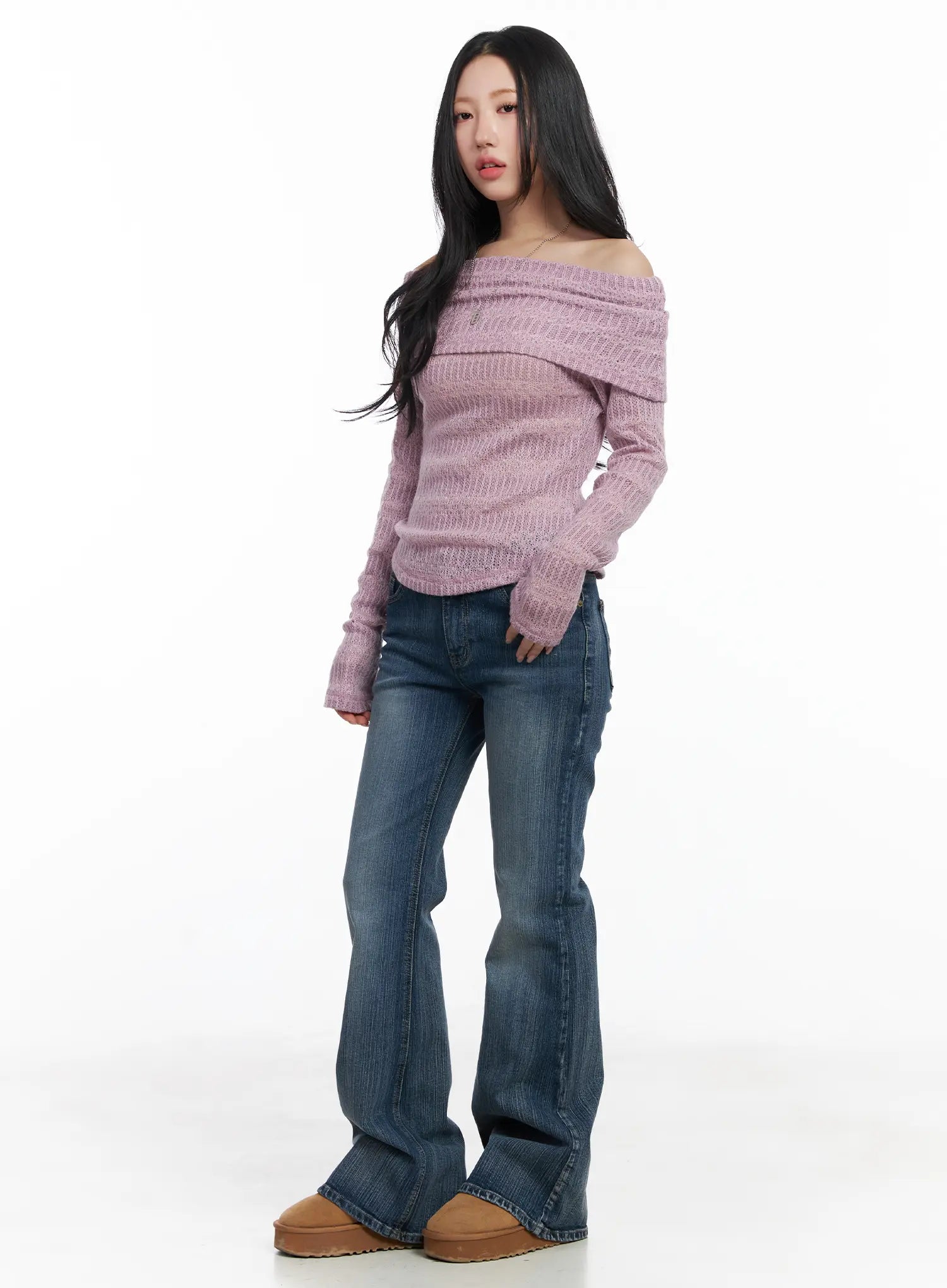 Astrid Low Rise Flared Bootcut Jeans CJ514 in blue, three-quarter front styling shot on model, flared long leg, low-rise fit, styled with pink off-shoulder knit top and tan platform shoes.