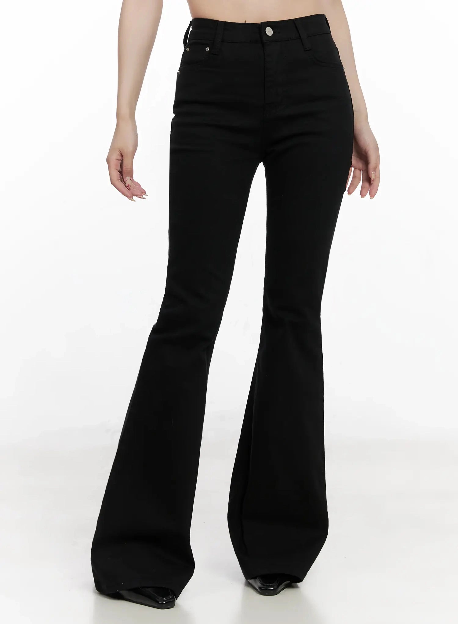 Dream Chic Black Flare Jeans IN514 in black, front cropped view on model, high-rise waistband with front pockets and silver rivets, wide bootcut flare, hands at sides.