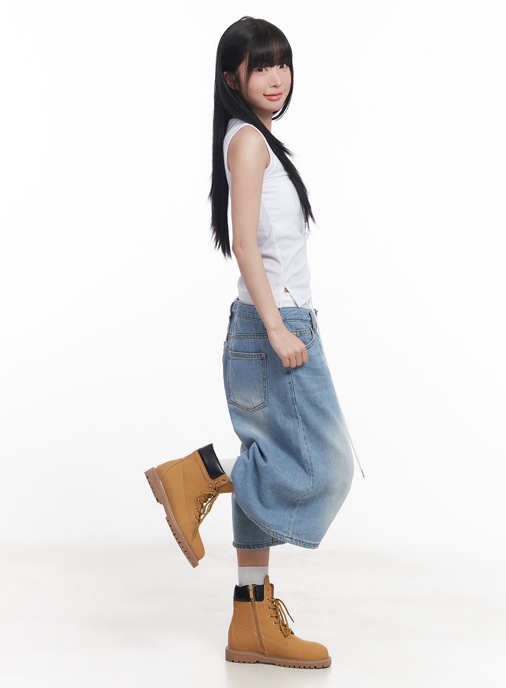 Layered Drawstring Baggy Jorts CY527 in light blue, side-back view on model, back pocket and wide-leg midi hem visible, styled with white sleeveless top and tan chunky boots, one leg raised.