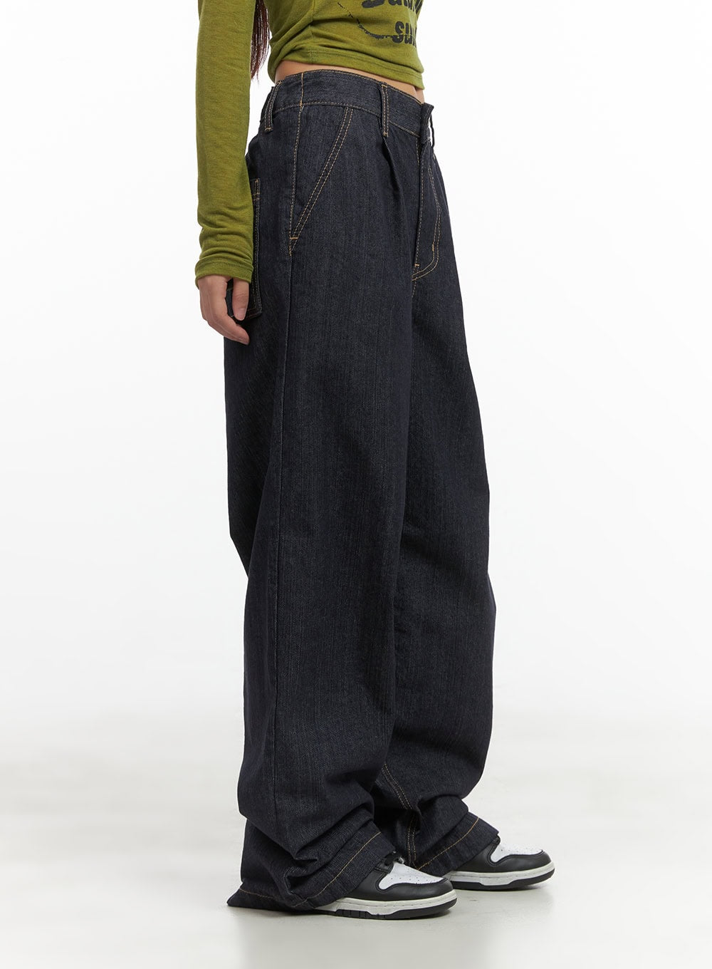 Lola Pintuck Baggy Jeans CO402 in dark blue, side close-up on model, highlighting pintuck pleat line, wide leg sweep, and gold contrast stitching on stiff cotton denim.