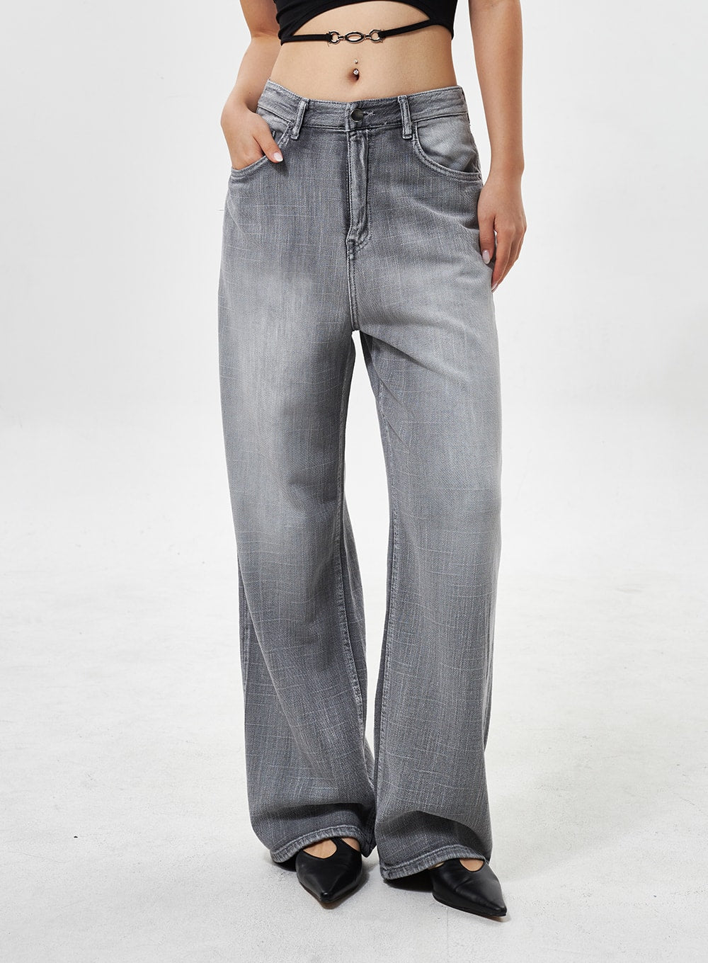 Mid-Rise Wide Leg Jeans CY330 in grey, front mid-shot close-up on model, mid-rise waistband with side pocket detail, faded wide-leg denim, hand in pocket.