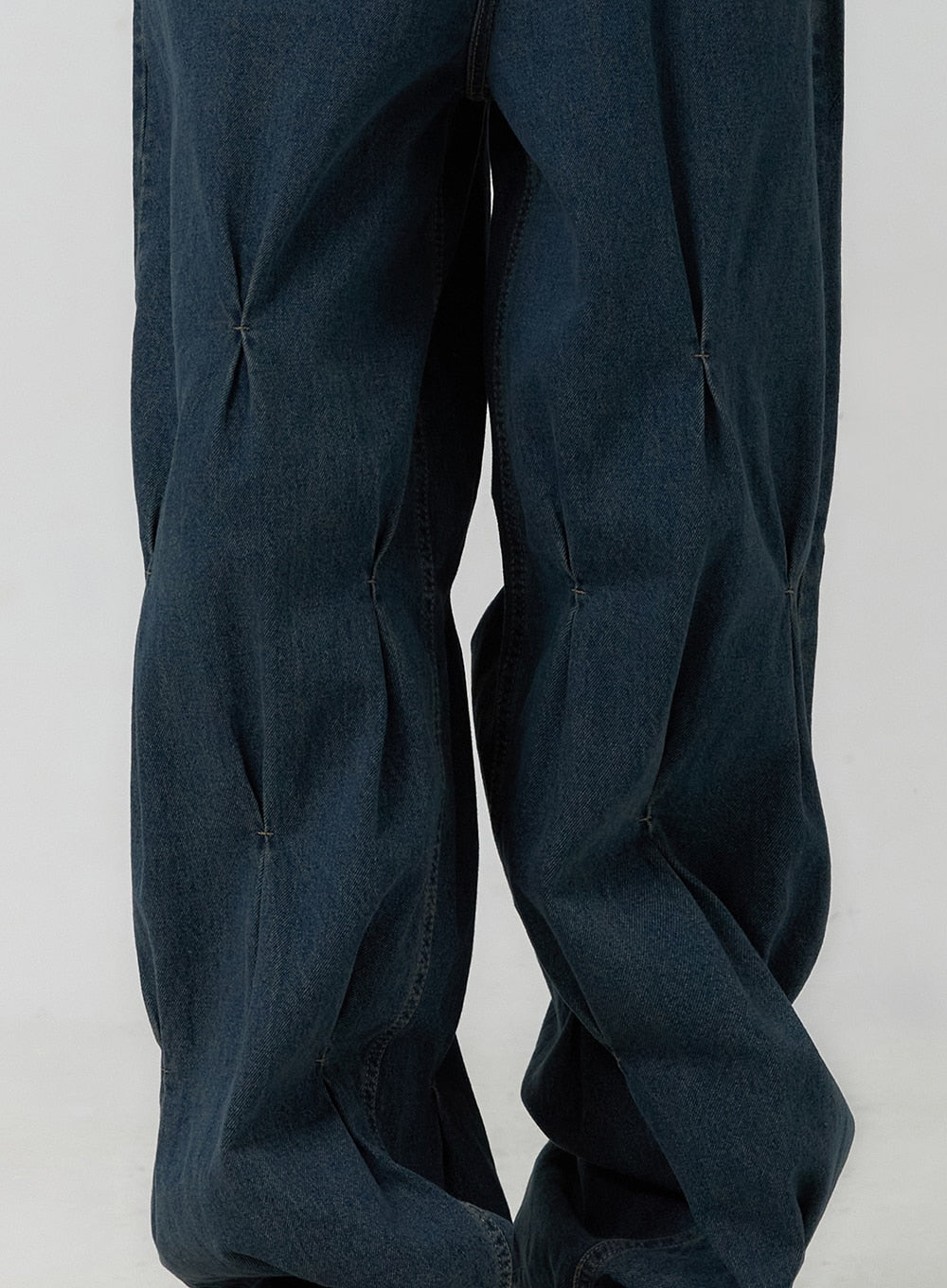 Quilted Wide Leg Denim CF406 in dark blue, close-up detail shot of quilted diamond pintuck stitching on wide leg panels, washed cotton denim texture clearly visible.