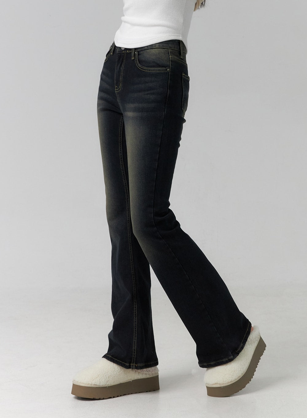 Washed Low Rise Bootcut Jeans CD308 in dark blue, side view close-up on model, bootcut flare from knee highlighted, slim thigh fit and tonal side seam stitching visible.