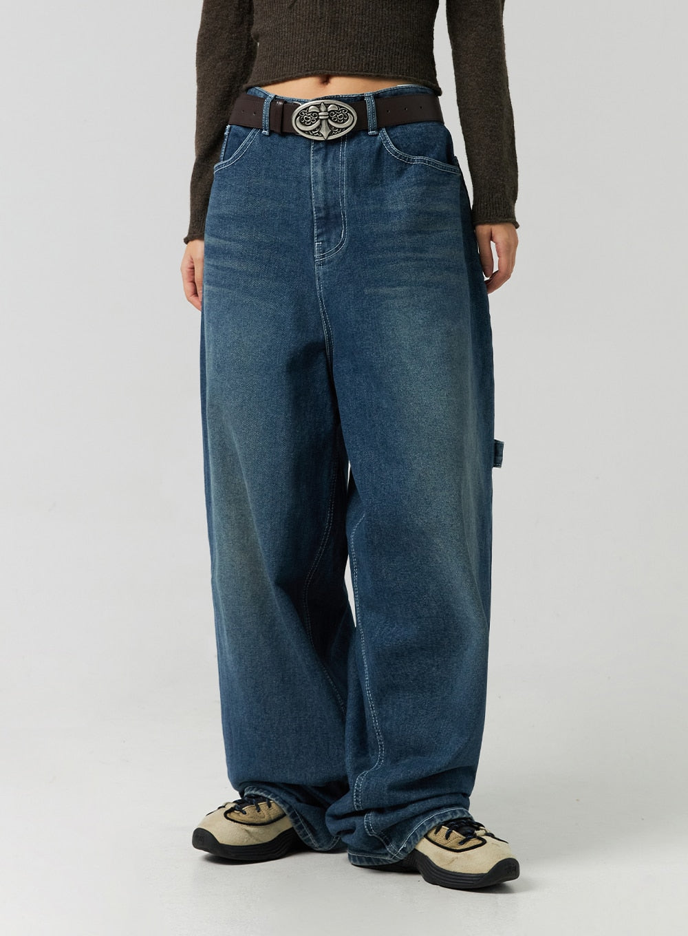 Washed Cotton Wide Leg Jeans CO323 in blue, front mid-section close-up on model, high-rise waistband with side carpenter seam detail, heavy washed cotton denim with slouchy wide leg.