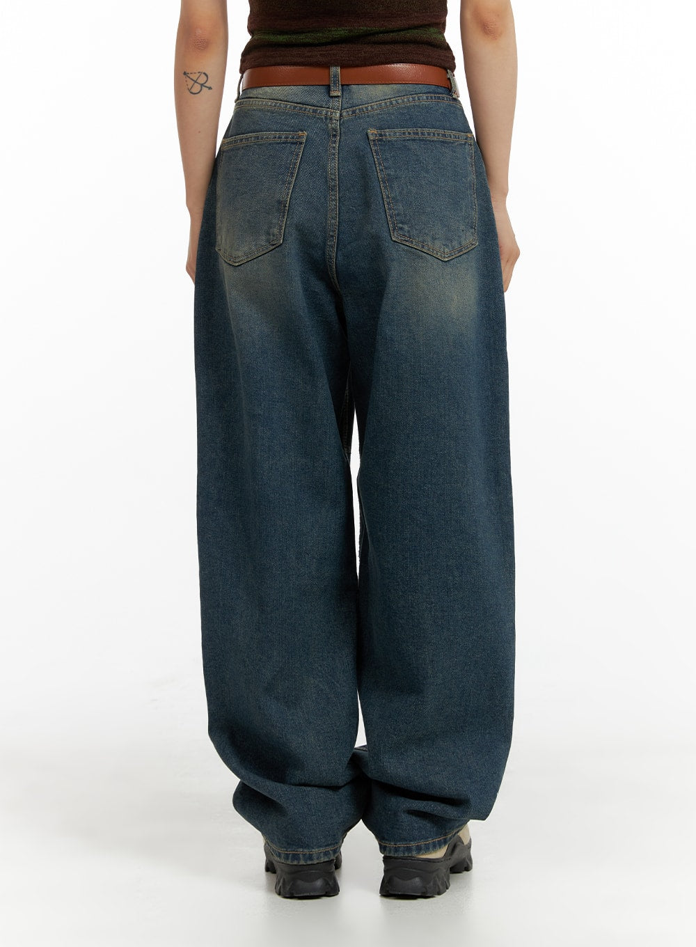 Scratch Textured Baggy Jeans CM405 in washed indigo blue, back full-length shot on model, showing classic back pockets, yellow-tint washed fading, voluminous wide-fit leg pooling at hem, with brown belt detail.