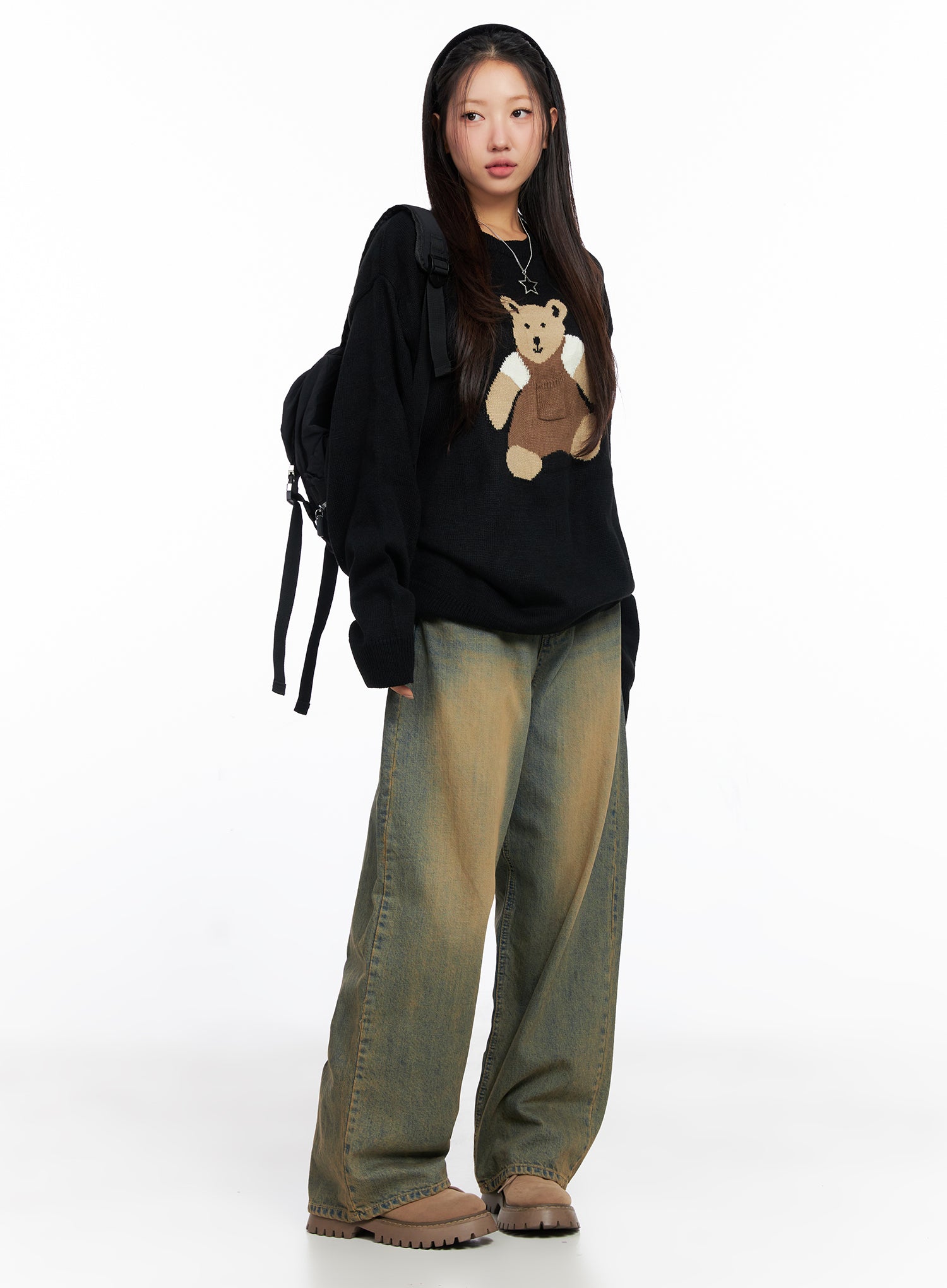 Miley Washed Balloon Baggy Jeans CO515 in vintage green-blue wash, full-body three-quarter view on model, wide fit cotton denim, styled with black bear knit sweater and black backpack.